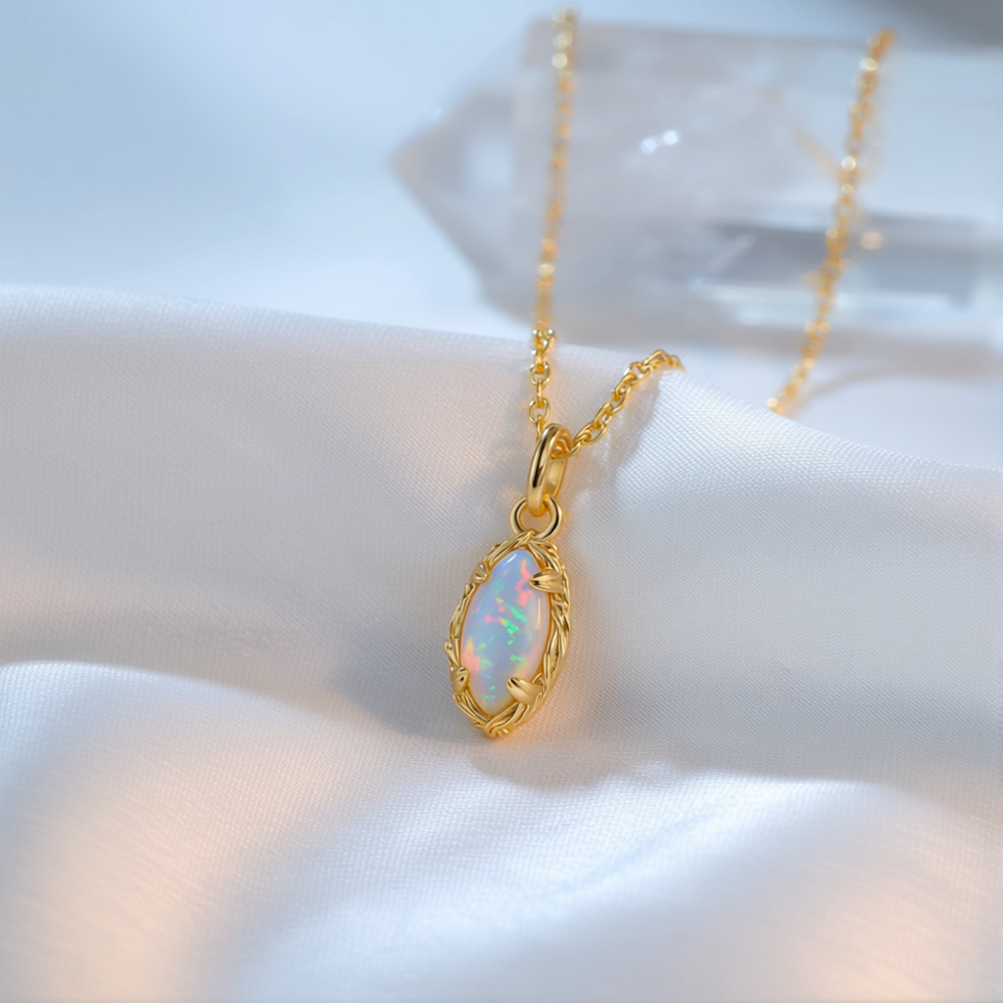 Close-up of the gold marquise-cut white opal pendant showing its iridescent play-of-color.