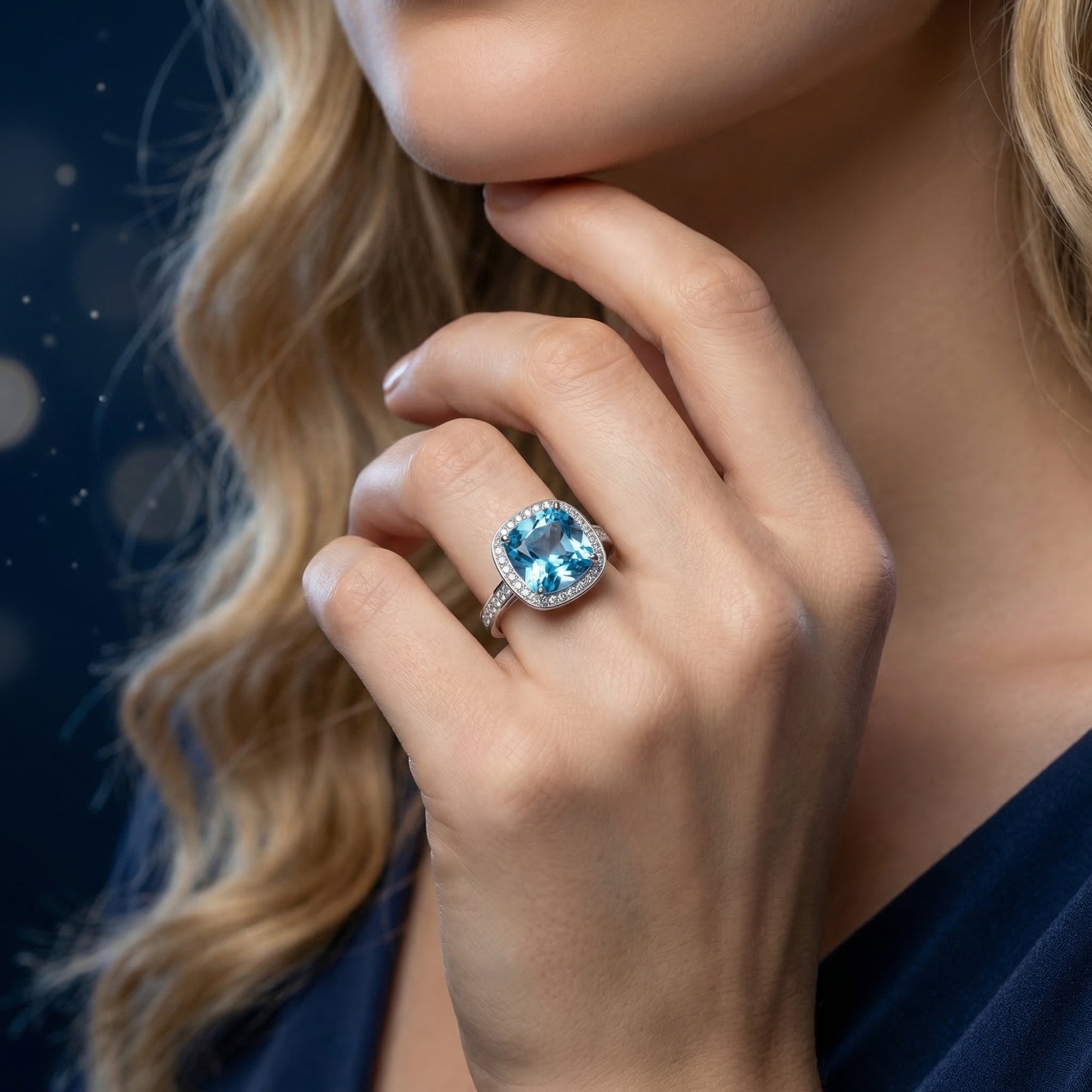 Aquadis natural blue topaz cushion cut ring in sterling silver shown on a model's hand.