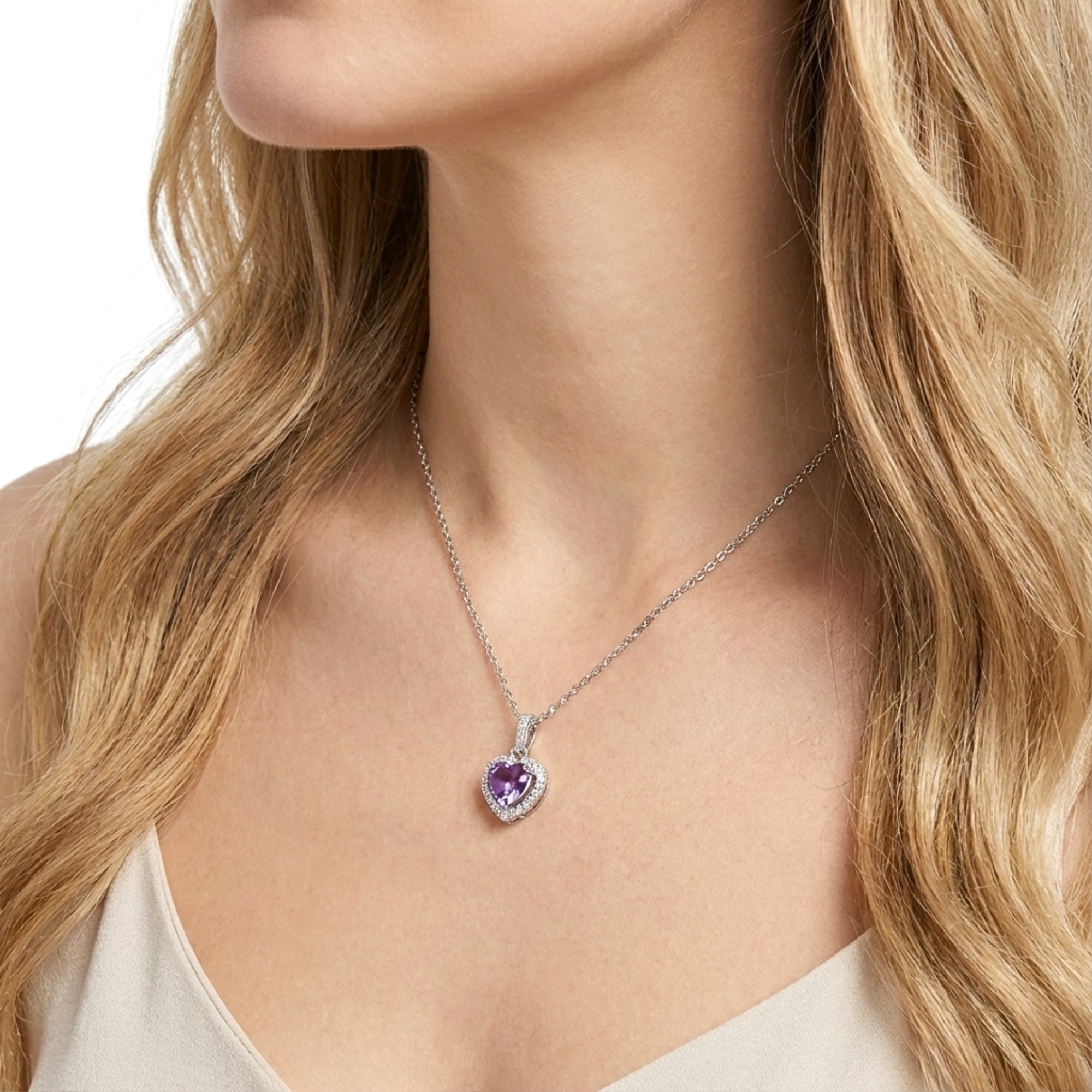 Angled view of a model wearing a heart-cut simulated amethyst halo necklace in S925 sterling silver.
