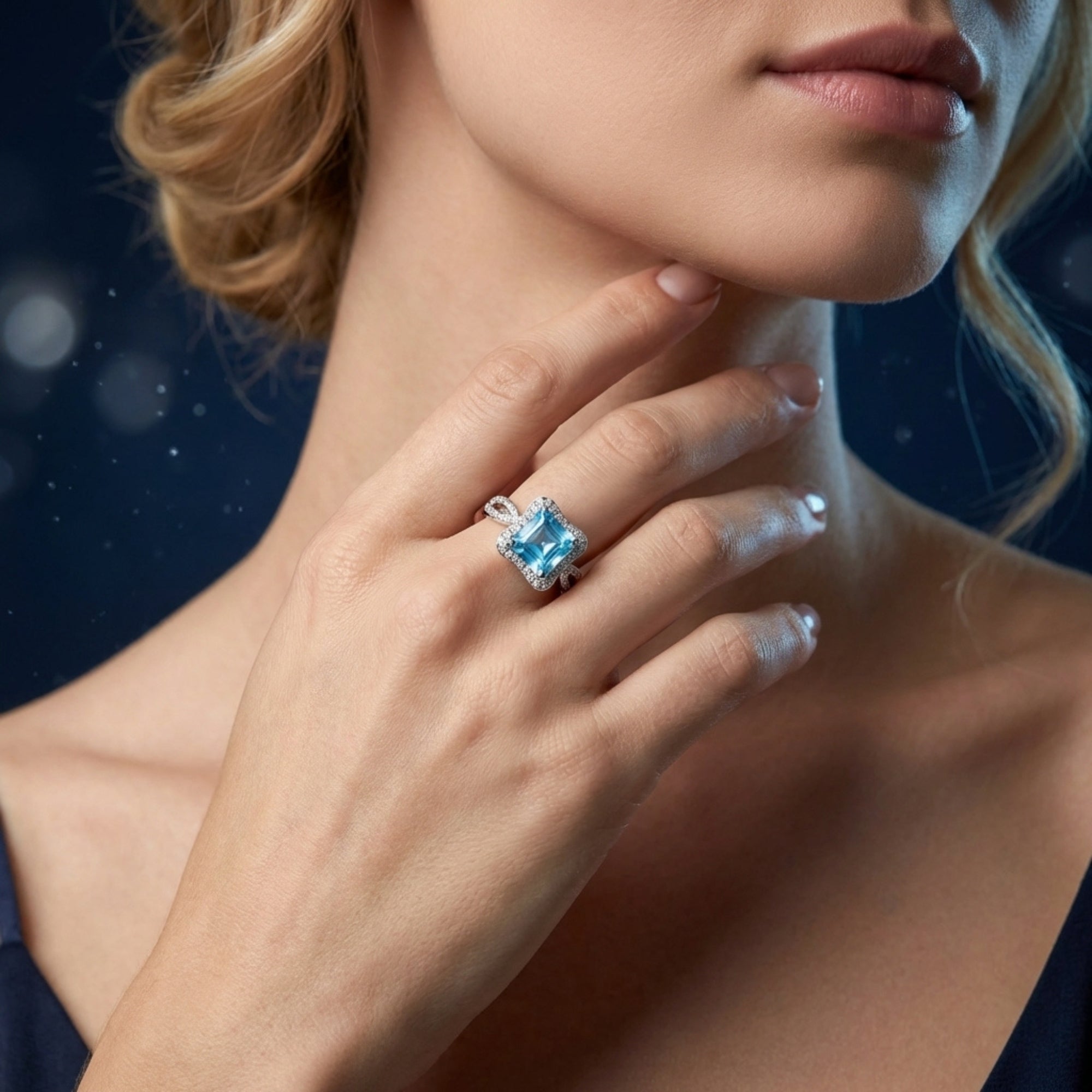 Model wearing the Aquadine Swiss Blue topaz sterling silver ring with a halo setting and pavé accents.