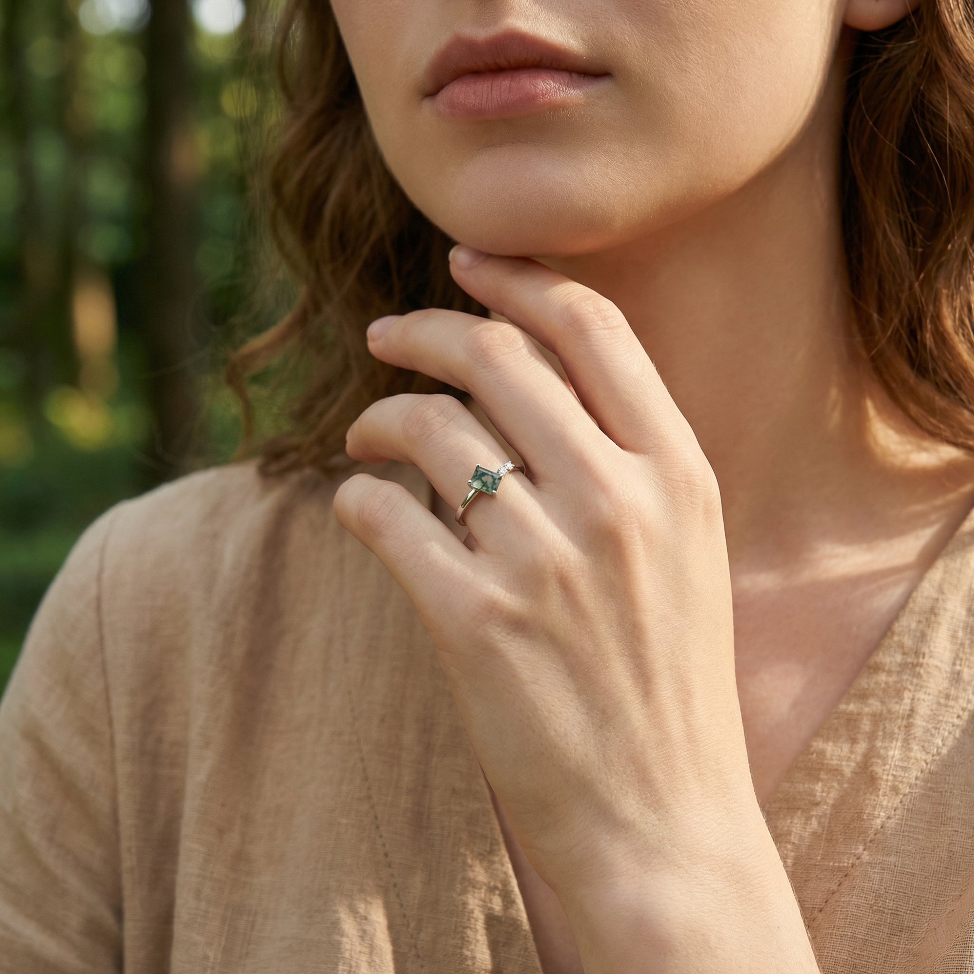 Model wearing the trio accent moss agate ring in S925 sterling silver against a natural outdoor backdrop.