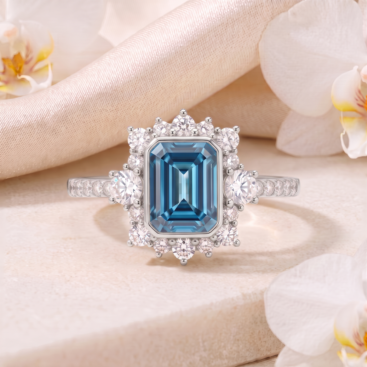 Front-facing view of an emerald-cut blue gemstone halo ring in white gold.