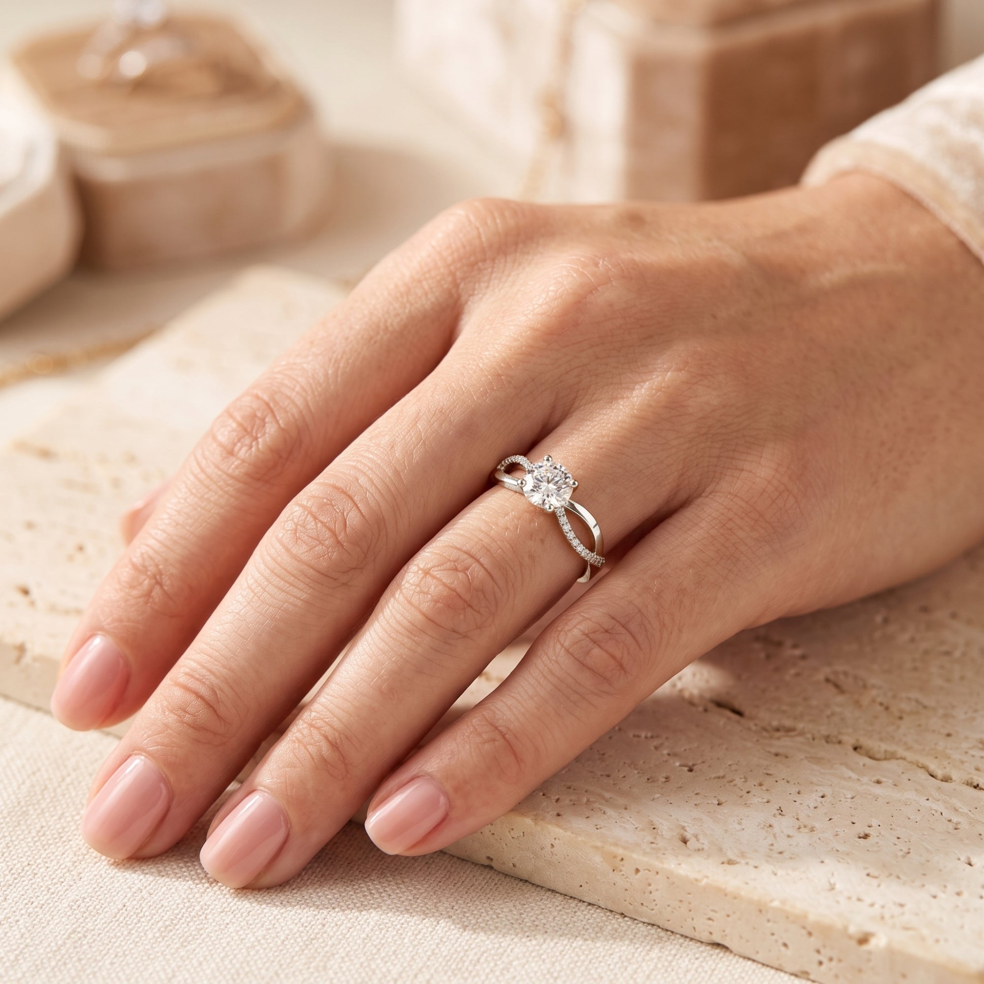 Sterling silver crisscross solitaire ring shown on a hand for scale.