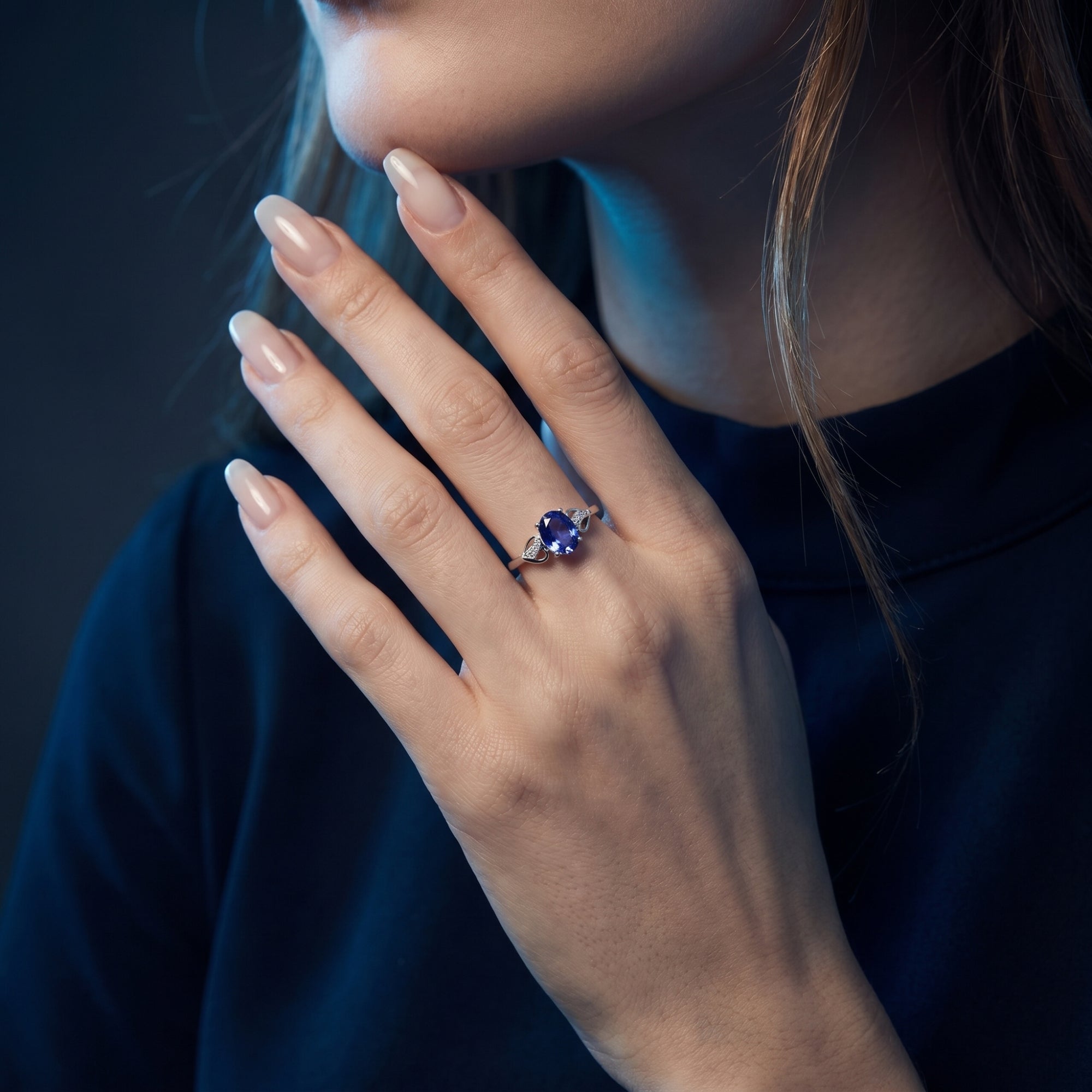 The Elysienne oval tanzanite ring in 18K white gold worn by a model, showcasing the gemstone's rich blue hue.