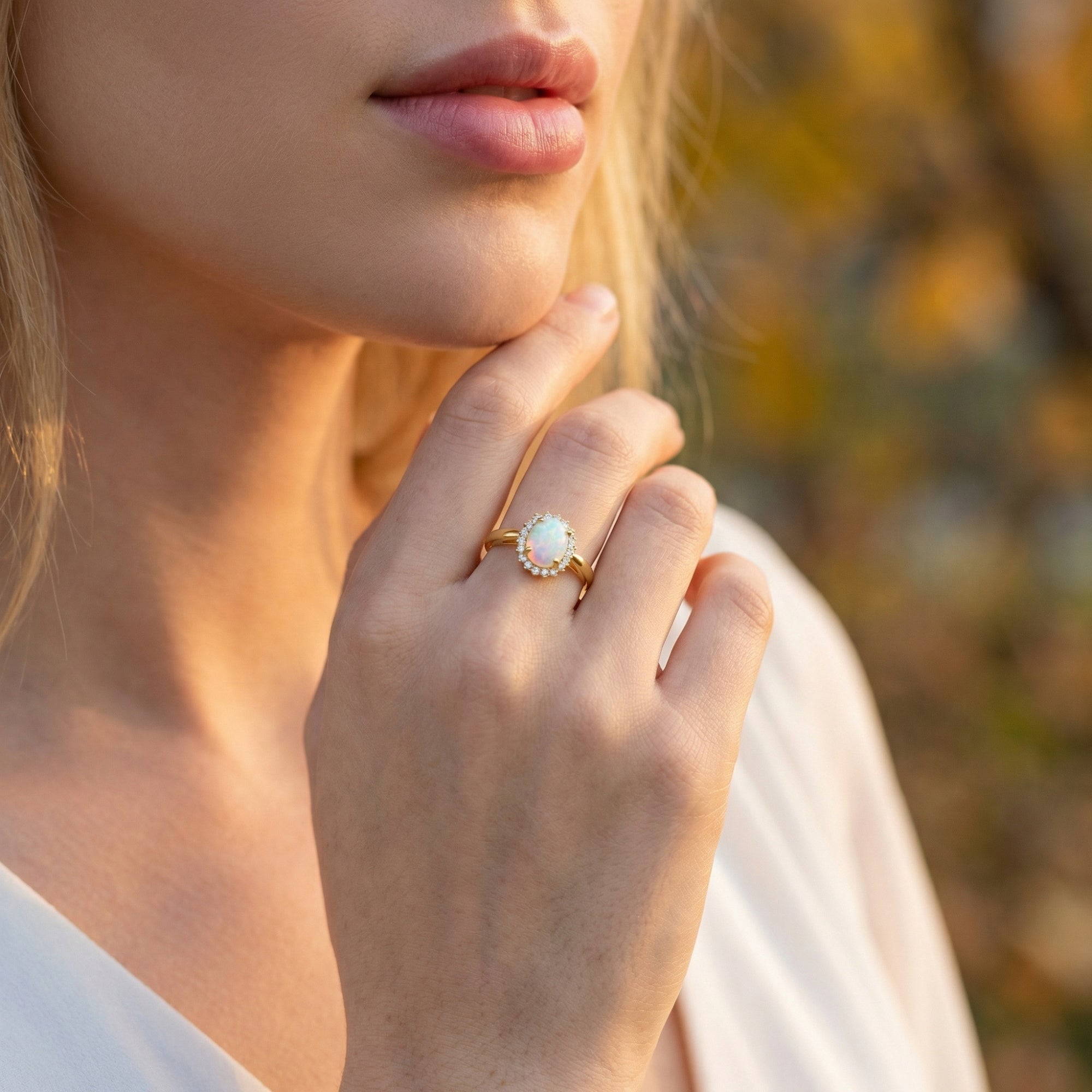 Model wearing the gold-tone oval opal stack ring outdoors, showcasing the jewelry in a natural light setting.