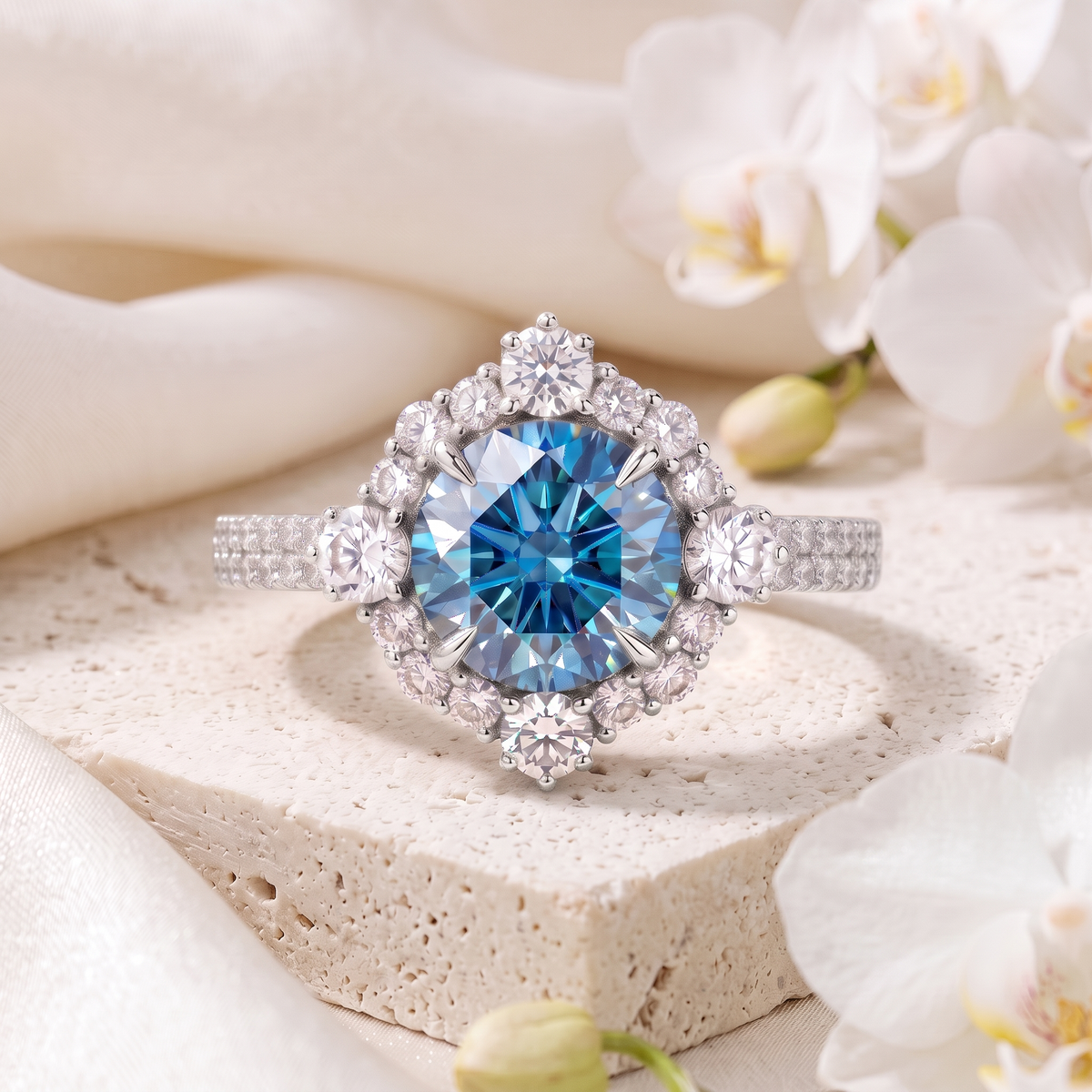 A white gold halo ring featuring a vibrant round blue moissanite surrounded by a cluster of white stones.