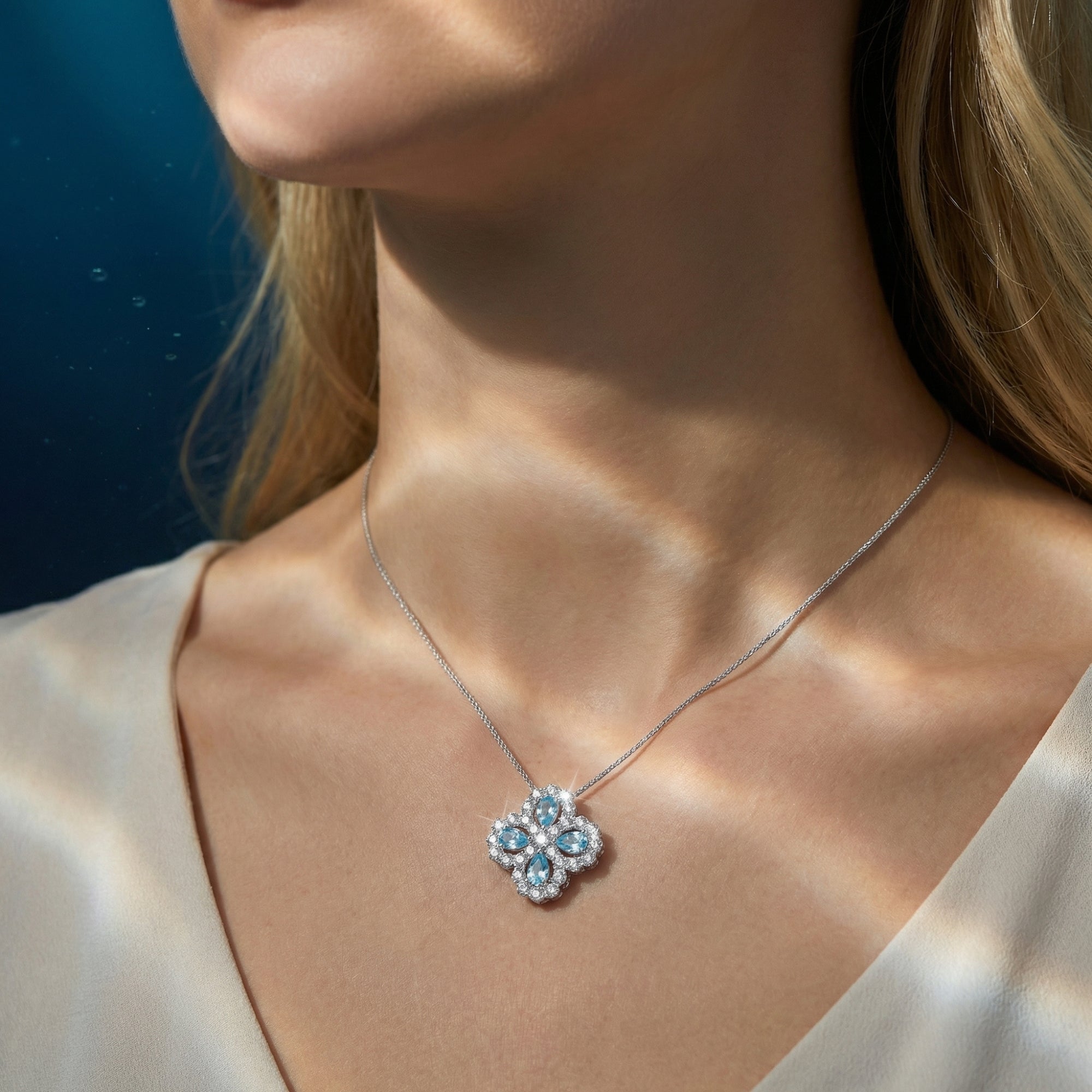 Aelinor aquamarine floral necklace in sterling silver worn by a model, showcasing its elegant scale.