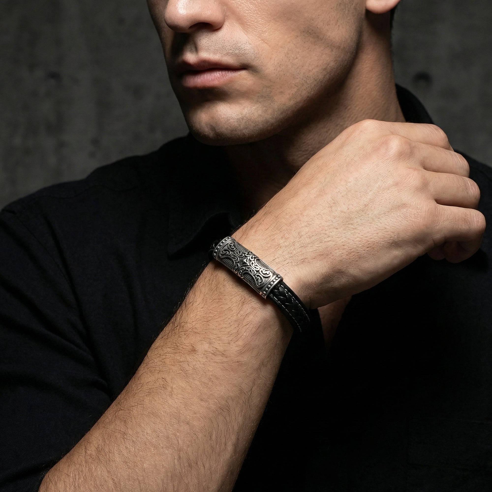 Men's Runeforge black leather bracelet with a heavy-duty stainless steel clasp styled on a model's wrist.