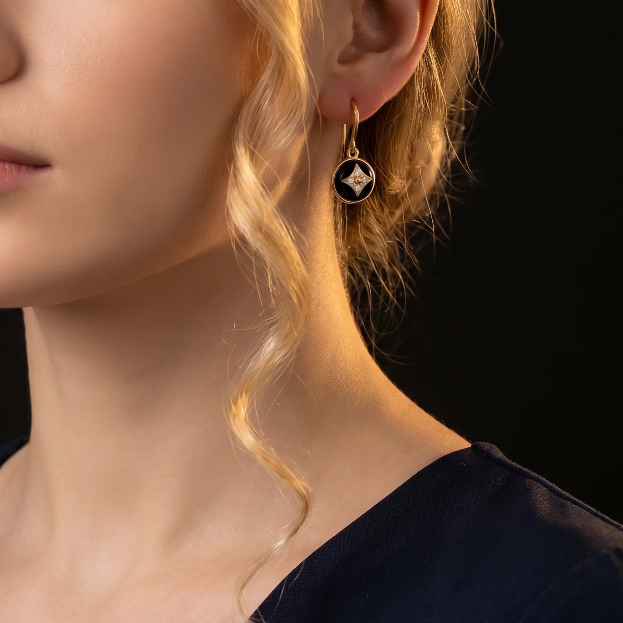 Model wearing a yellow gold Vespera Onyx drop earring, showcasing its elegant hang and bold black gemstone.