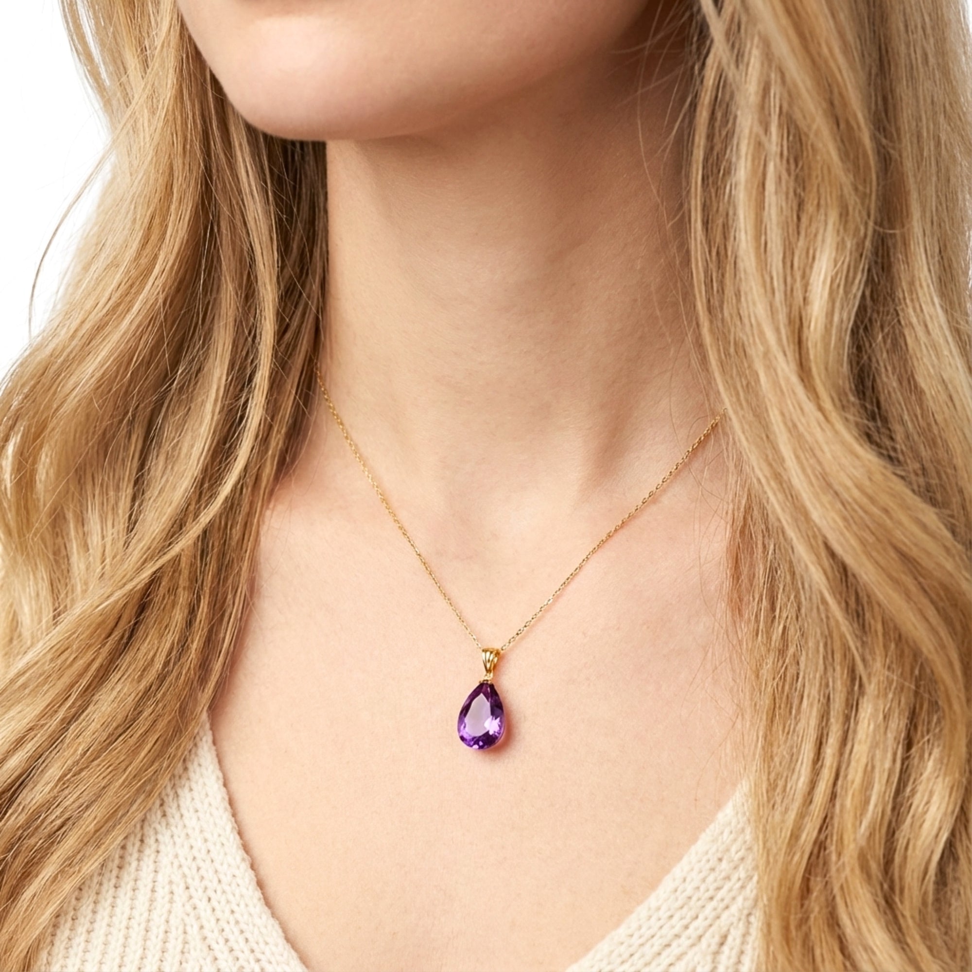 Close-up of a model wearing the teardrop cut simulated amethyst necklace in 18K gold vermeil.