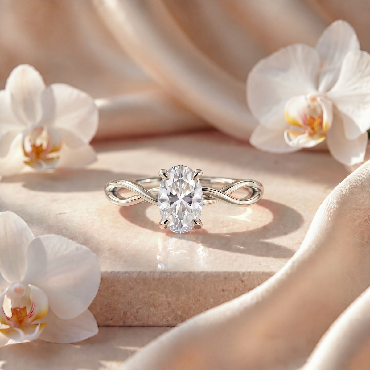 An oval moissanite engagement ring in white gold with a woven infinity band.