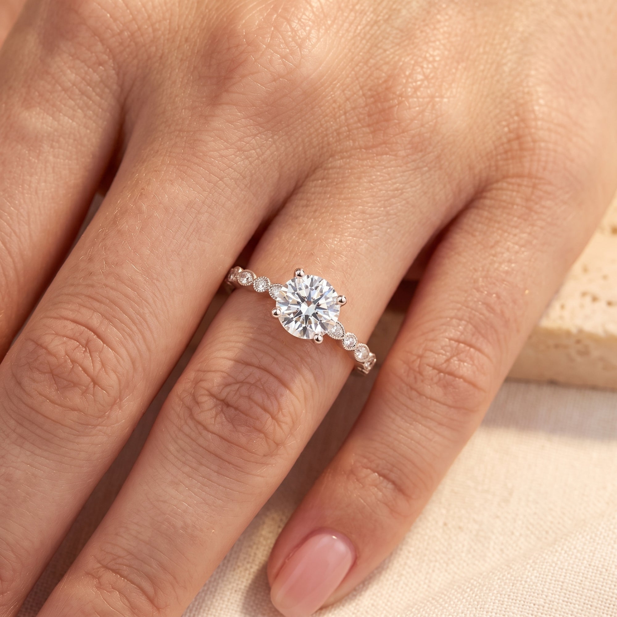 Close-up of a round cut cubic zirconia solitaire ring in sterling silver on a model's finger.