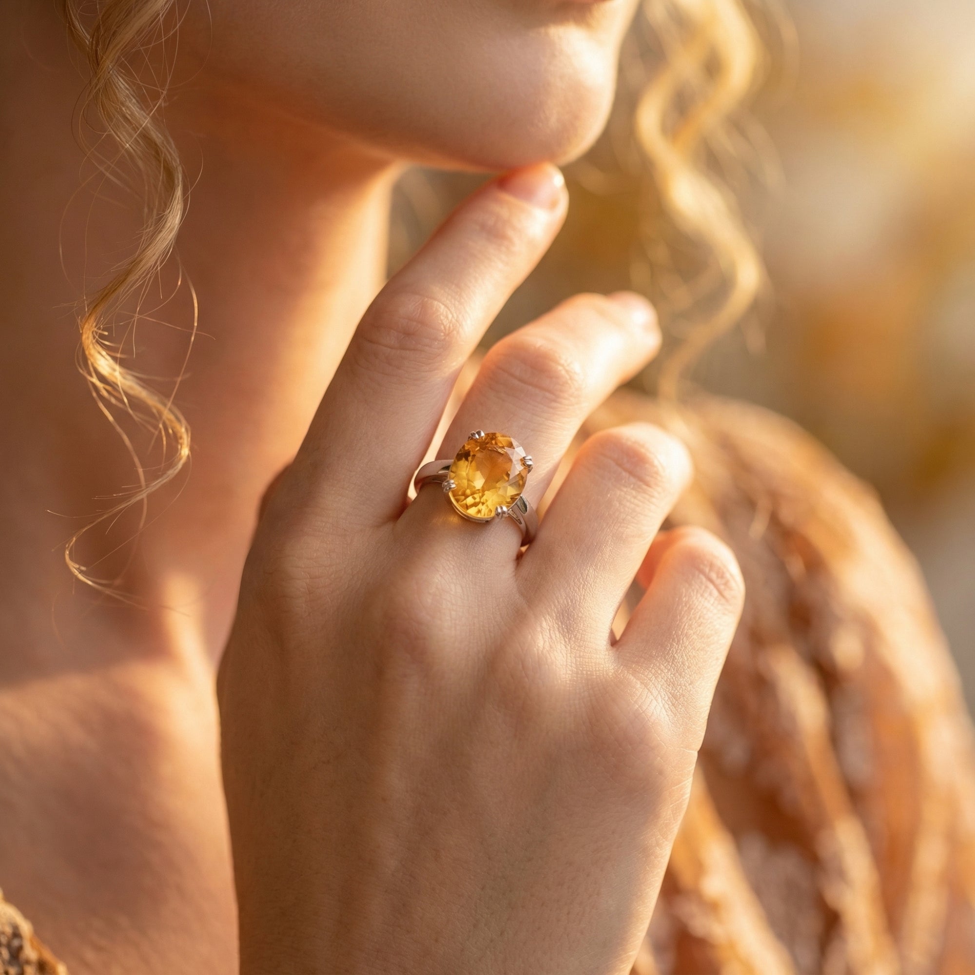 The Heliantha oval natural citrine sterling silver ring worn by a model in soft light.