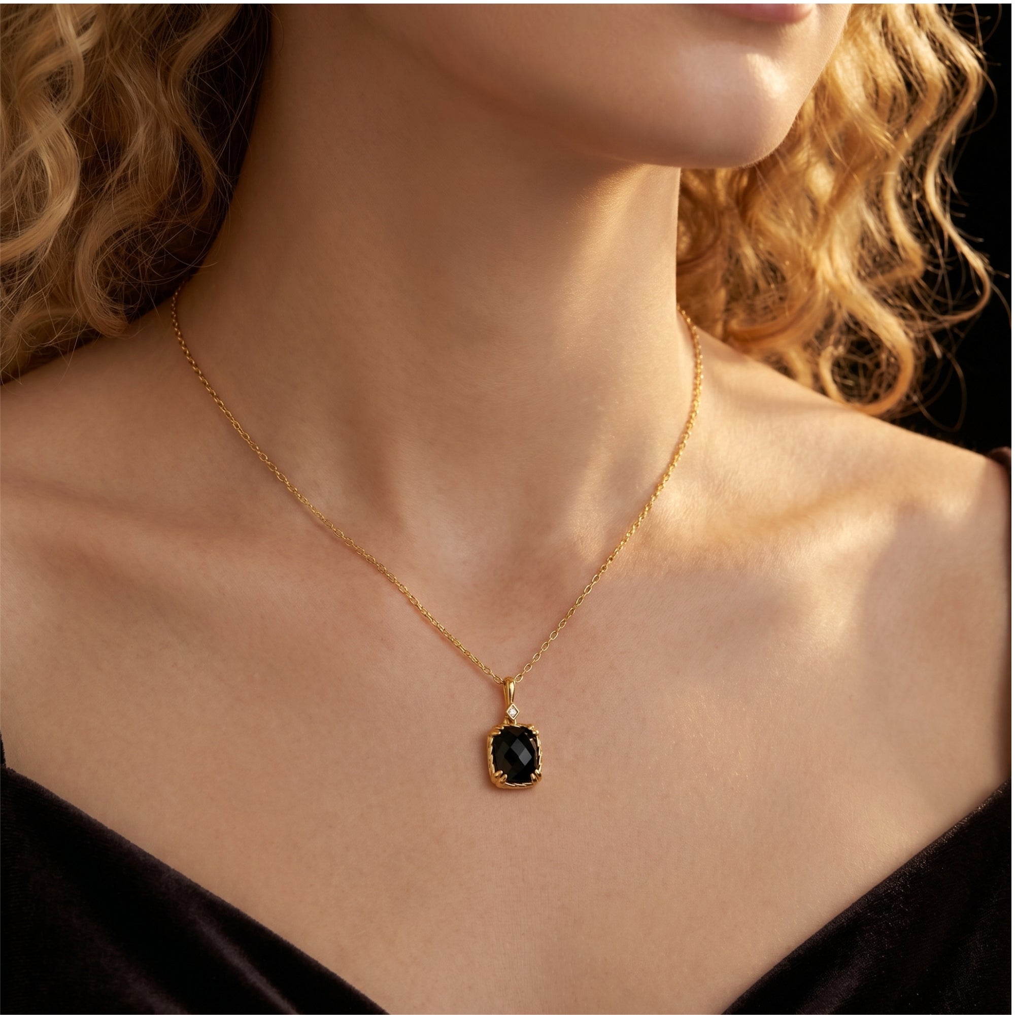 Yellow gold Eclipsia necklace with a cushion-cut black onyx pendant, shown worn by a model.