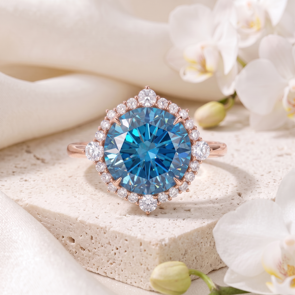 Rose gold blue moissanite halo ring displaying a brilliant round blue central stone on a textured stone block.