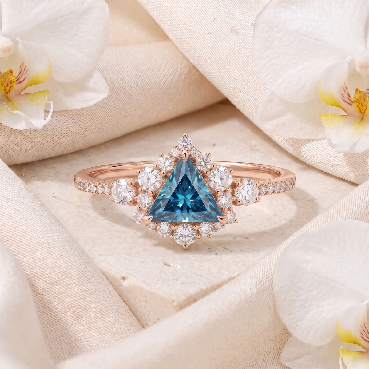 Rose gold triangle cut blue gemstone engagement ring with diamond halo and pavé band.