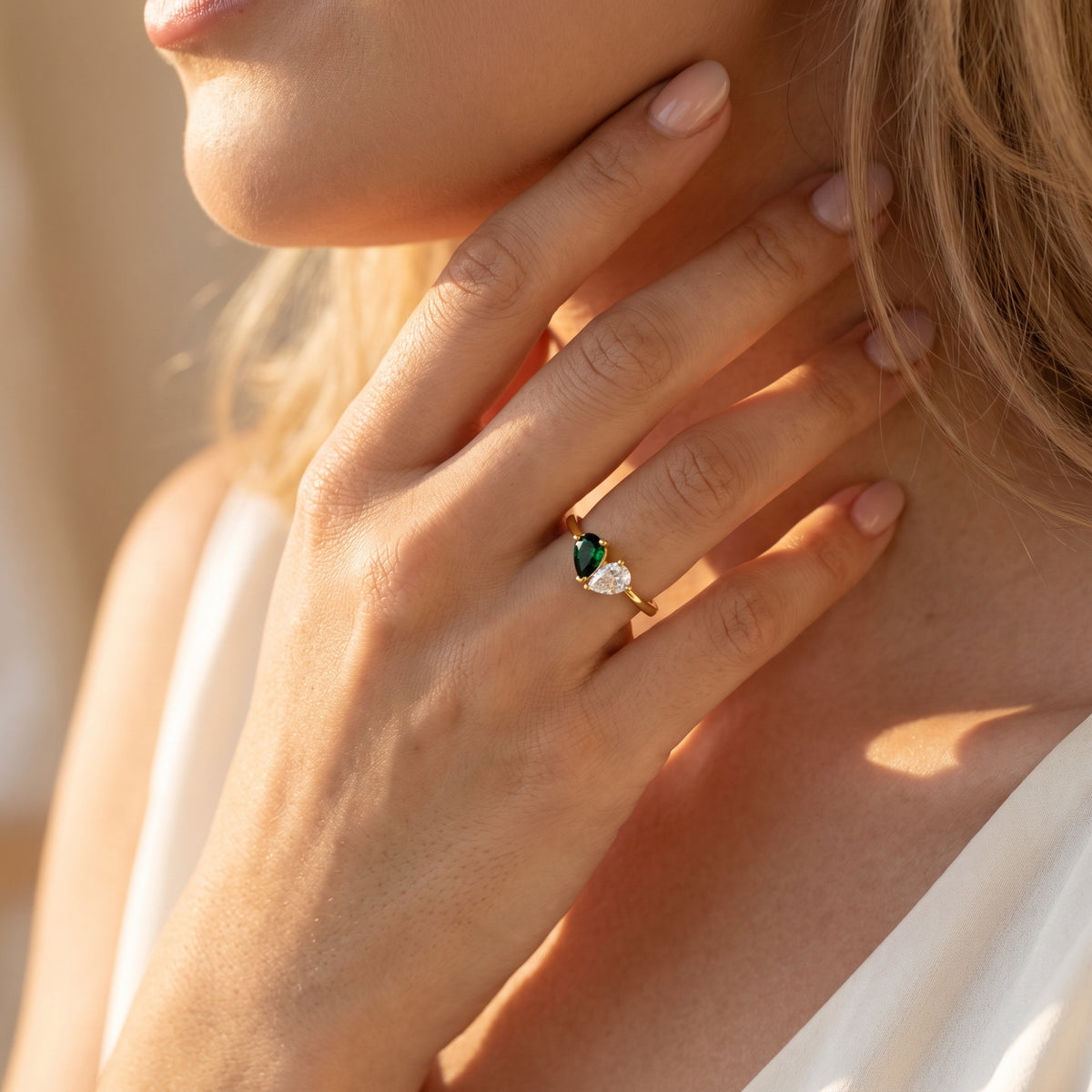 Gold-tone pear-stone ring on hand close up