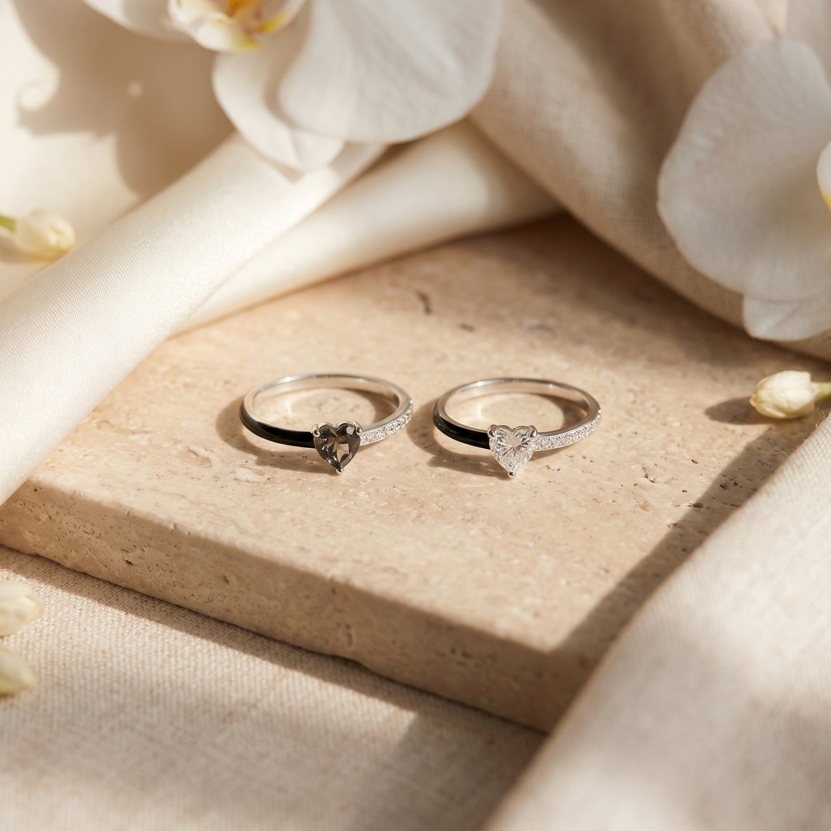 Black-heart and clear-heart versions of the silver enamel ring side by side.