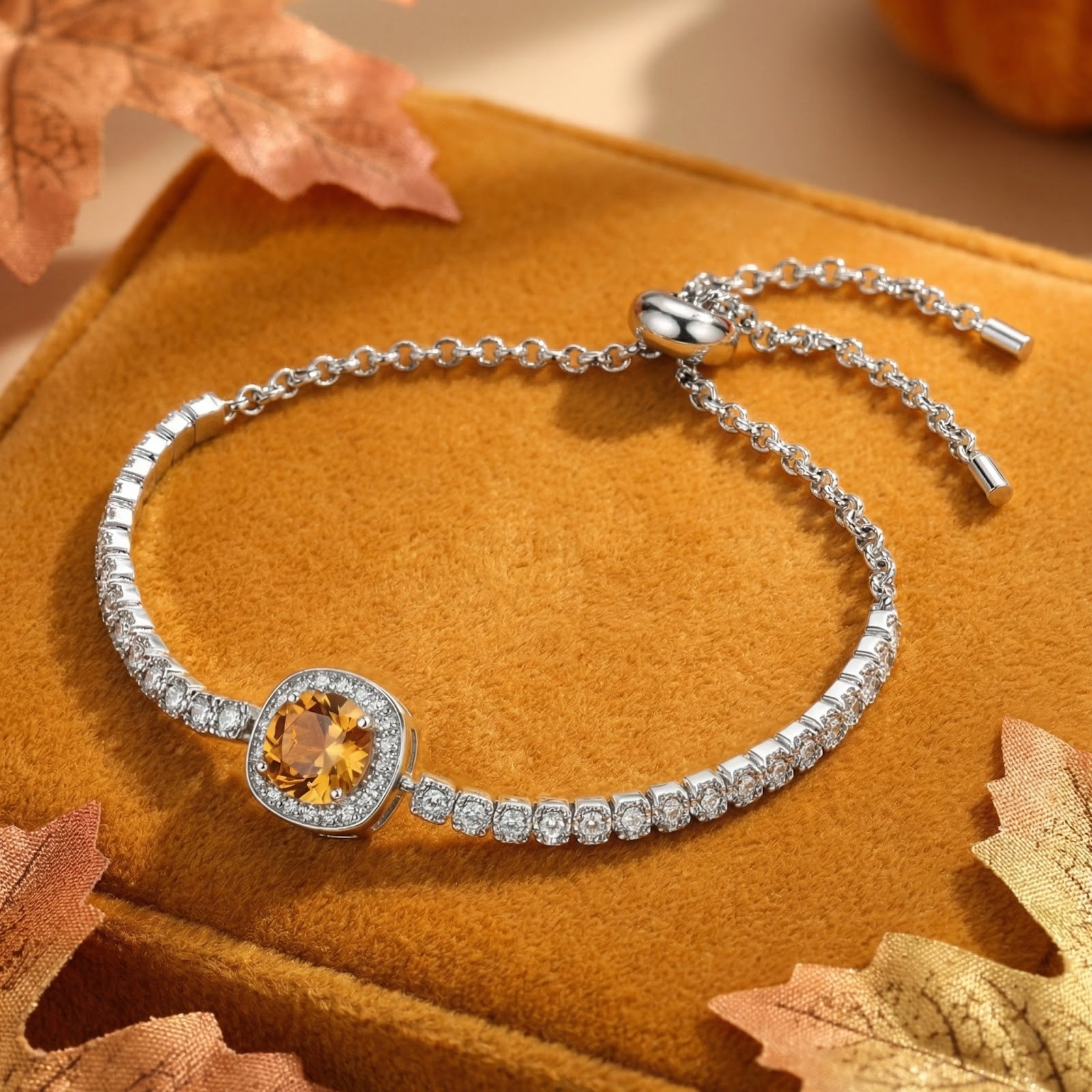 Sterling silver Luceria halo bracelet with a round golden-orange simulated topaz on an autumn lifestyle background.
