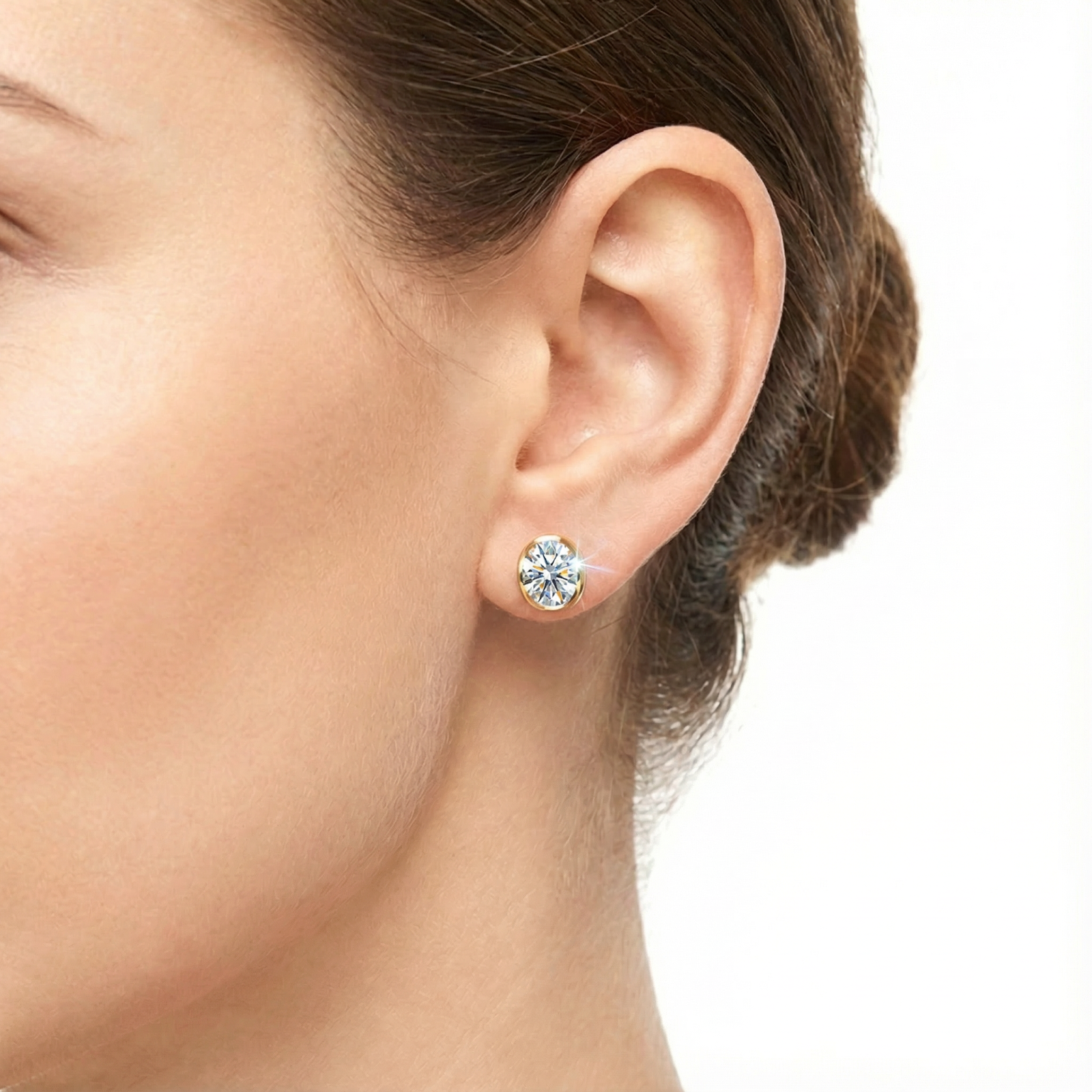 Classic profile view of a model wearing the Alysse 18K gold vermeil oval cut zirconia stud earring.