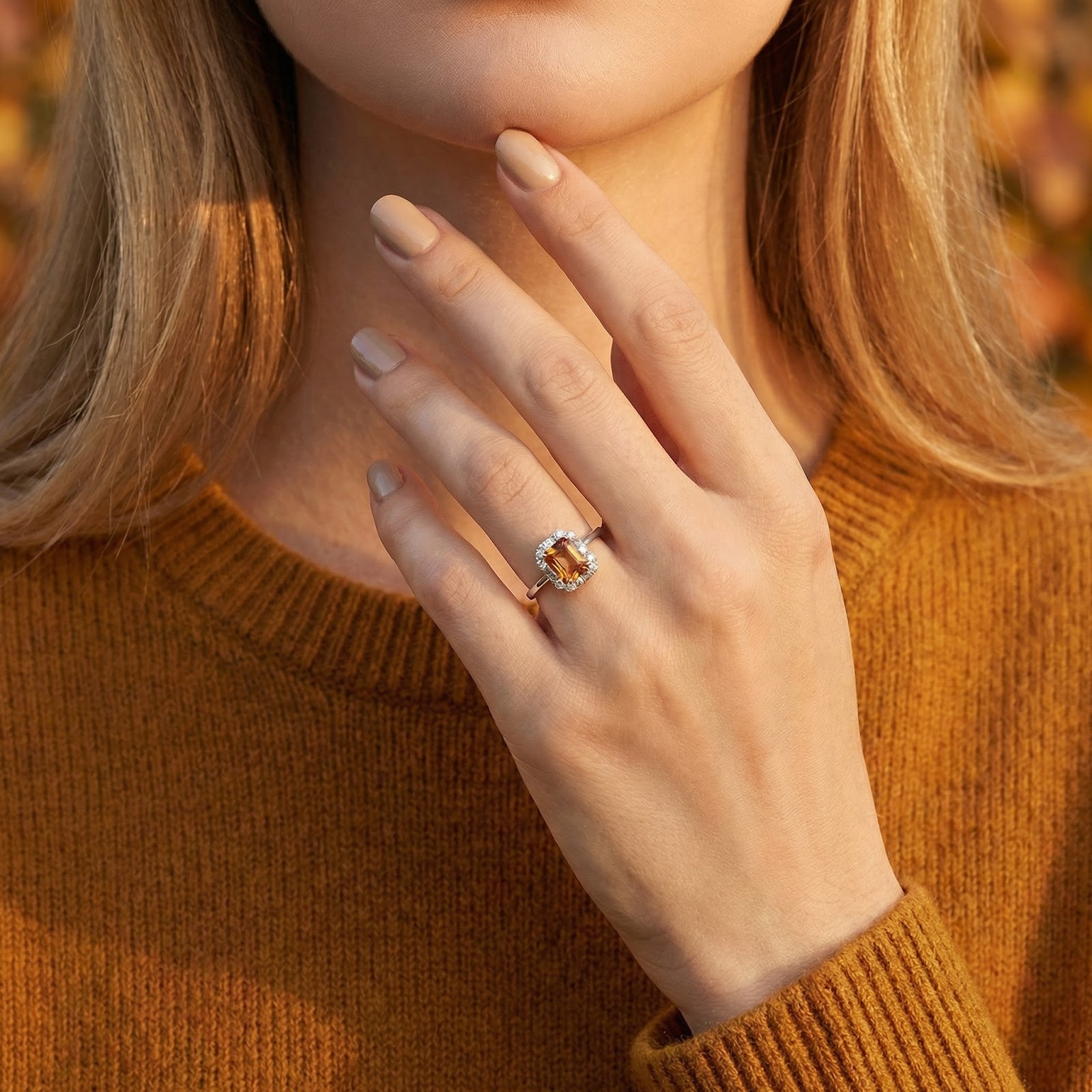 Model wearing the Lysandra octagon simulated topaz ring in sterling silver, paired with a warm autumn sweater.