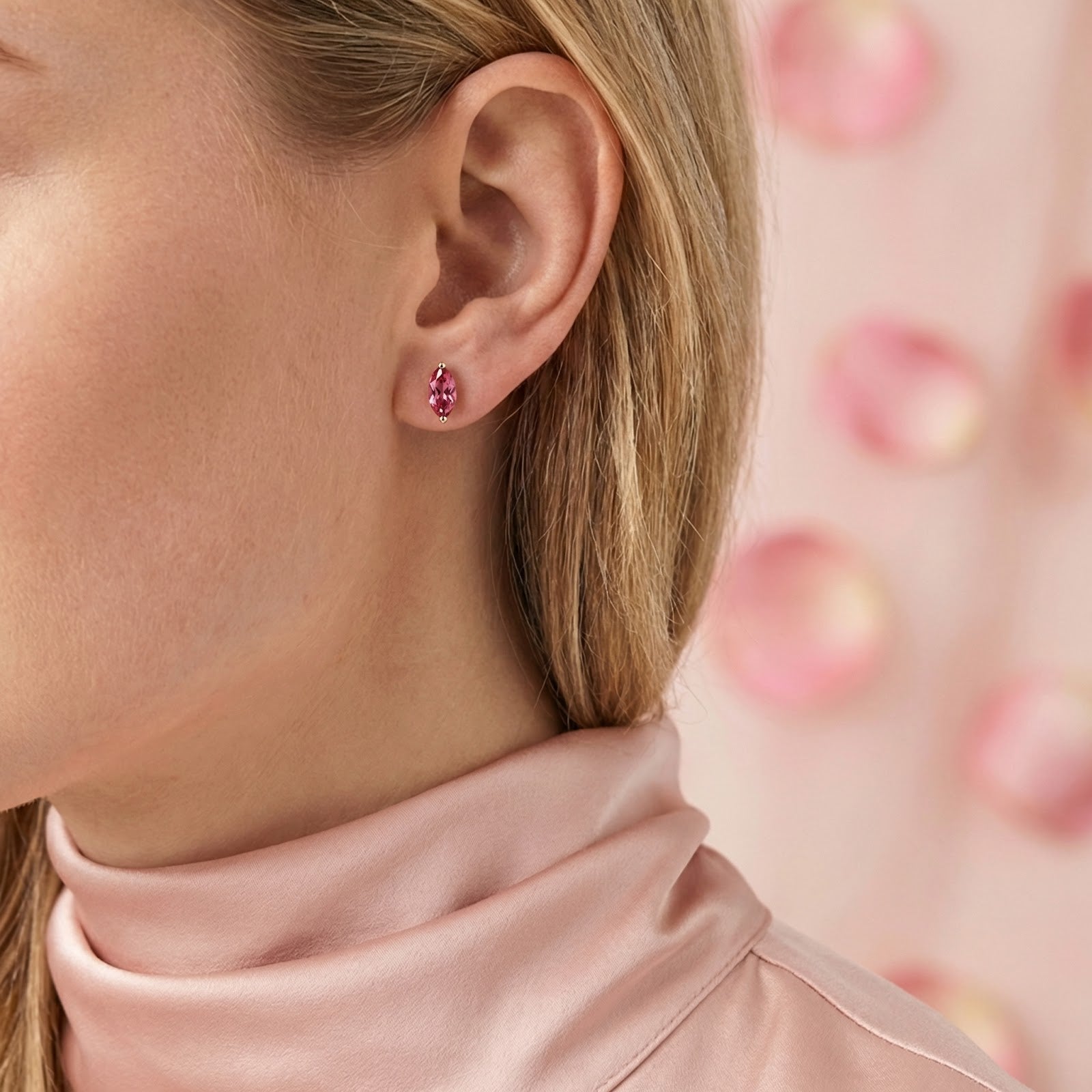 Model wearing a marquise-cut pink tourmaline earring in 18K gold vermeil with a pink silk blouse.
