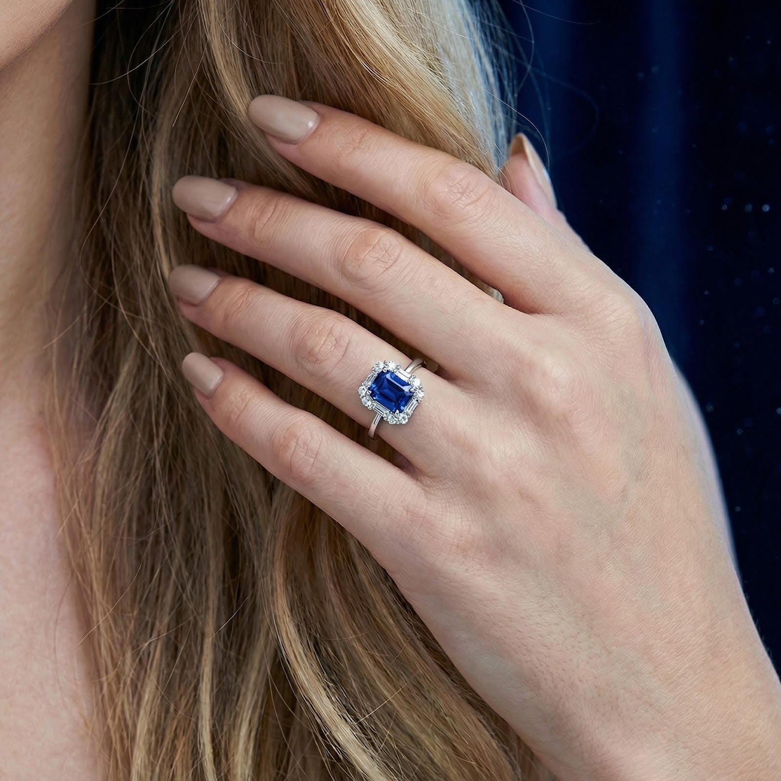 Close-up of the octagon-cut simulated sapphire sterling silver ring worn on a model's hand.