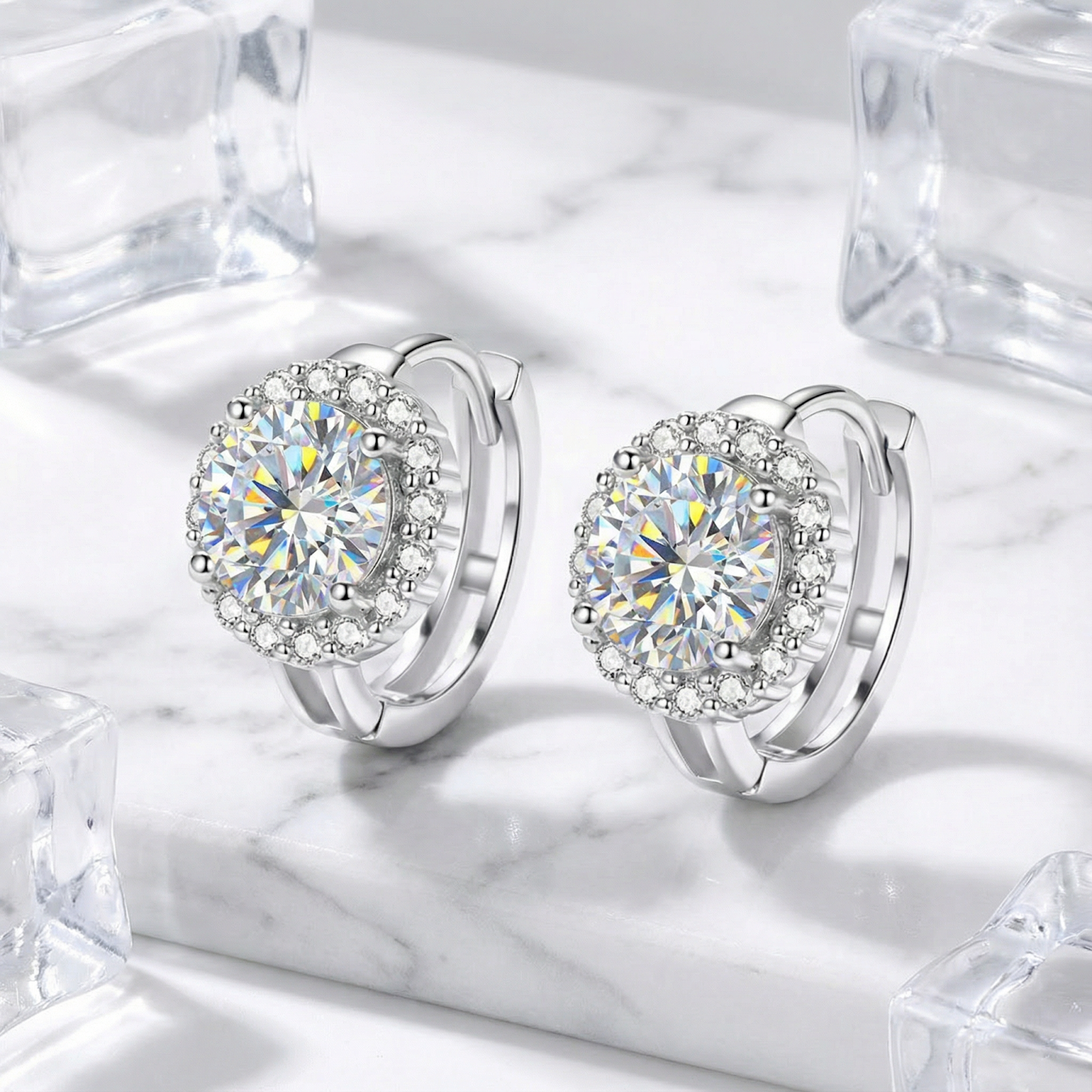 Pair of S925 sterling silver halo earrings with brilliant round cut moissanite stones on a marble background.