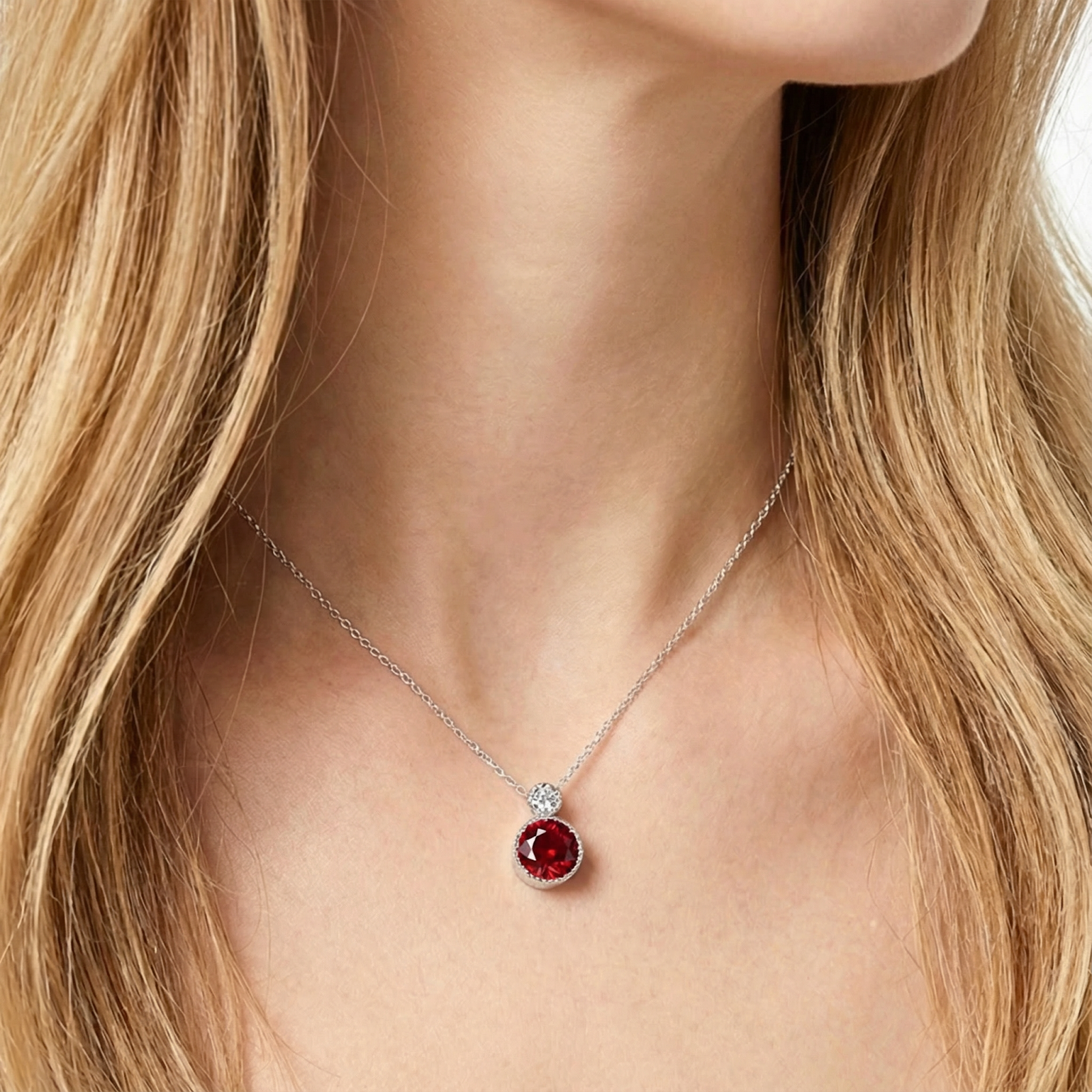Close-up of the July birthstone simulated ruby necklace in S925 sterling silver on a model's neck.