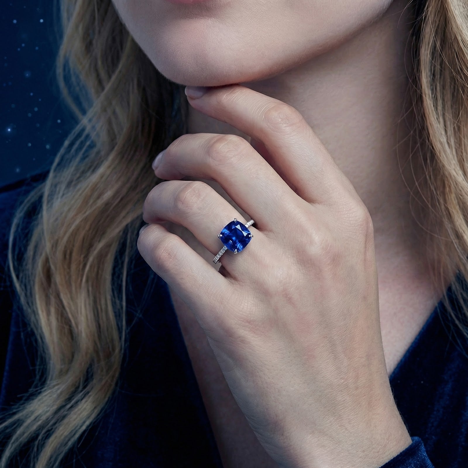 Model wearing the Arwenna cushion cut simulated sapphire ring in S925 sterling silver on her finger.