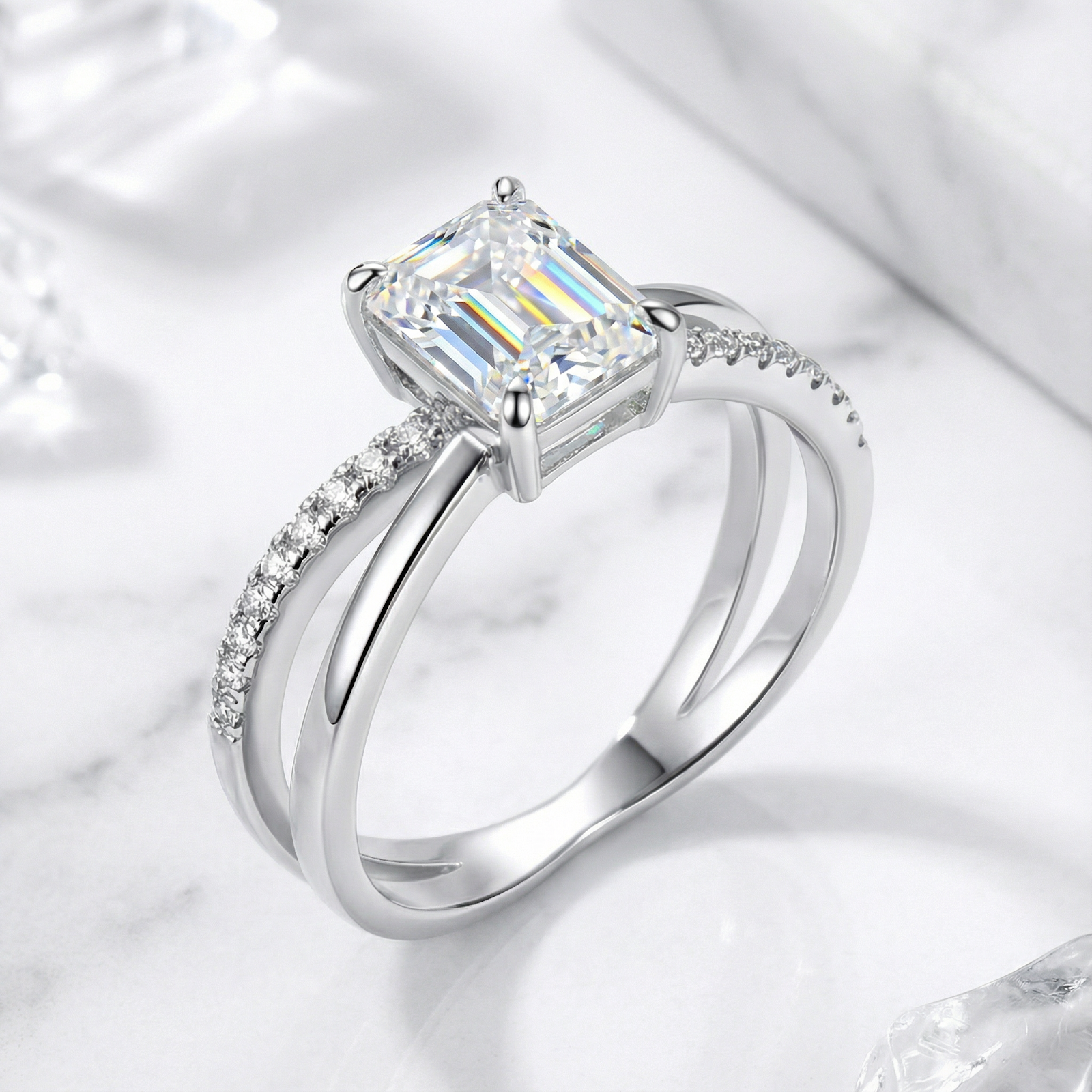 Angled view of the S925 sterling silver radiant cut simulated diamond ring showing the bypass setting and pavé stones.