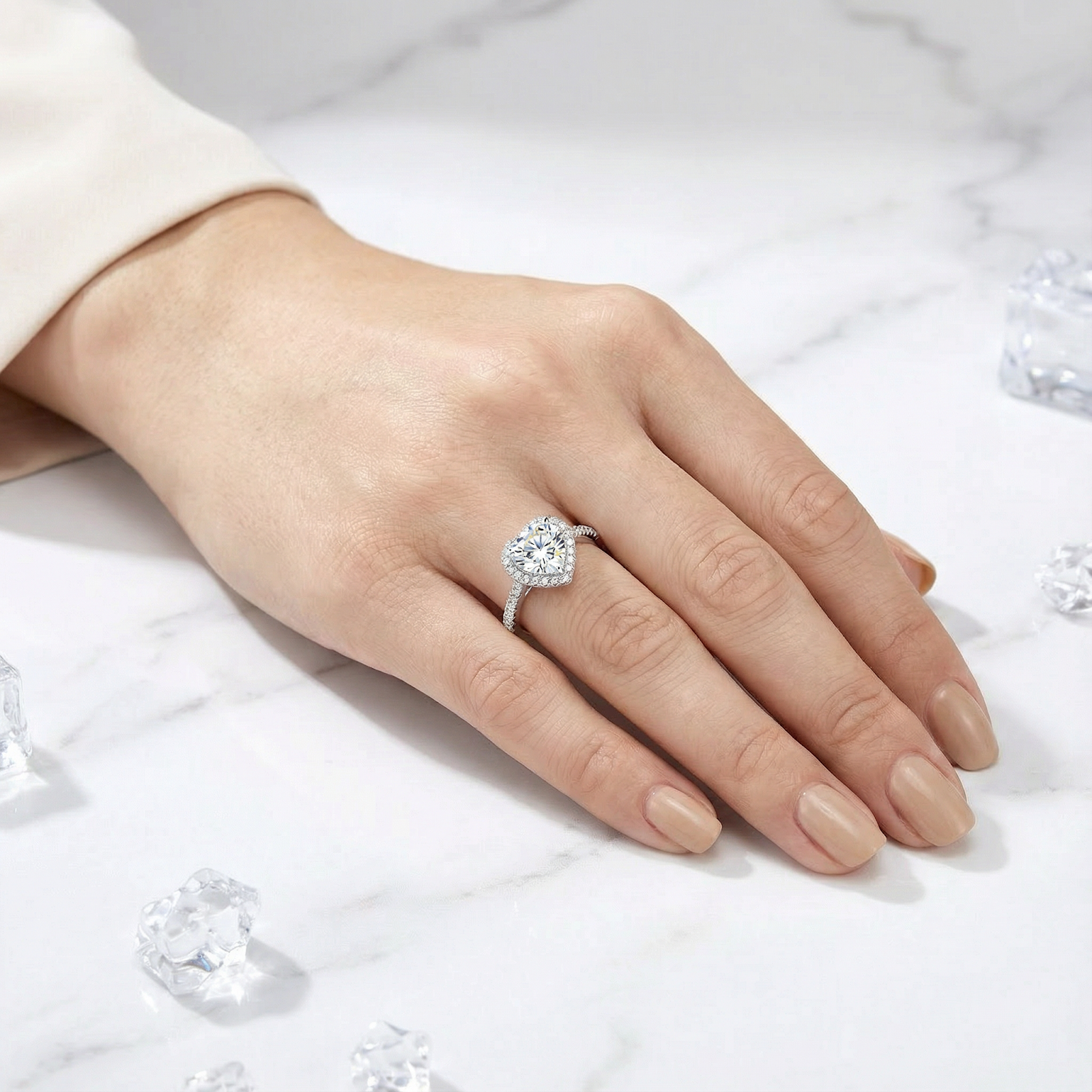 Top view of the heart-shaped simulated diamond halo ring in S925 sterling silver on a woman's hand.