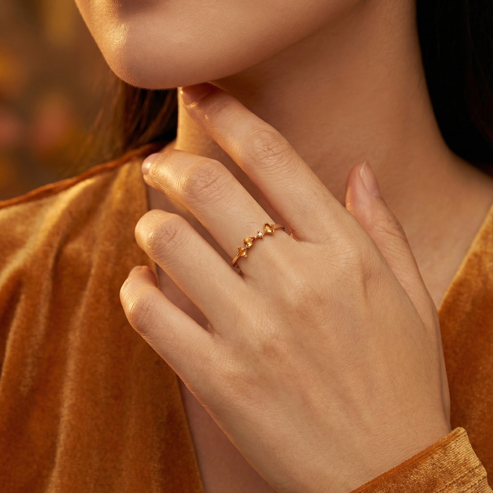 Model wearing the 18K gold vermeil Kalisara Row ring with honey-colored simulated topaz stones on her finger.