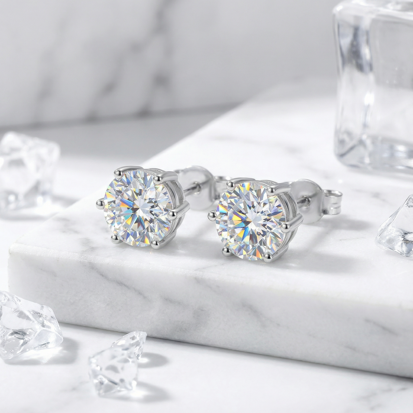 Macro view of round cut simulated diamond stud earrings in a 6-prong sterling silver setting.