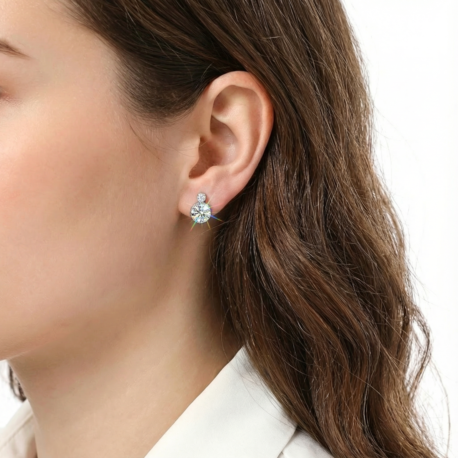 Round cut simulated diamond stud earring in S925 sterling silver worn on a model's ear.