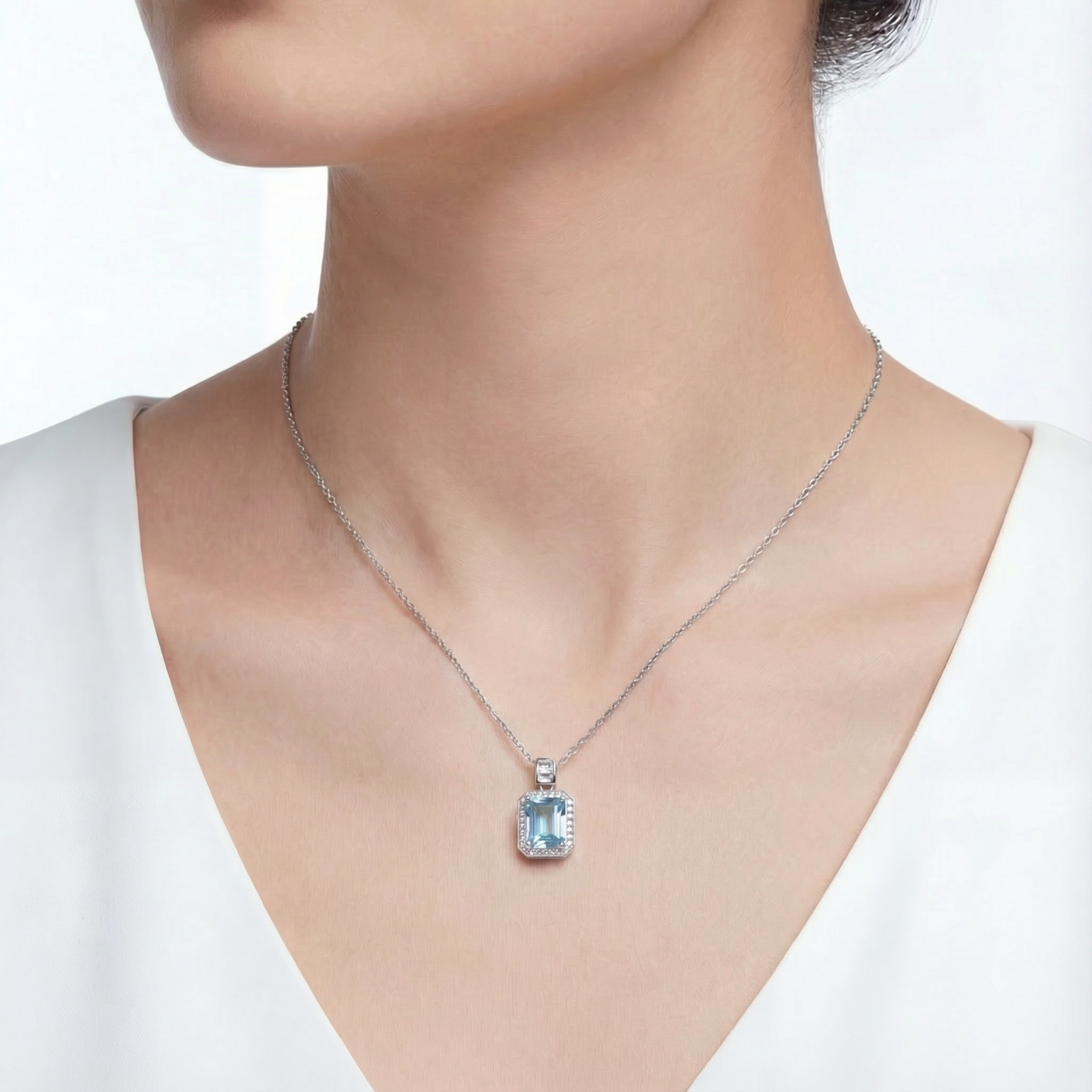 March birthstone simulated aquamarine necklace in sterling silver shown on a model's neck.