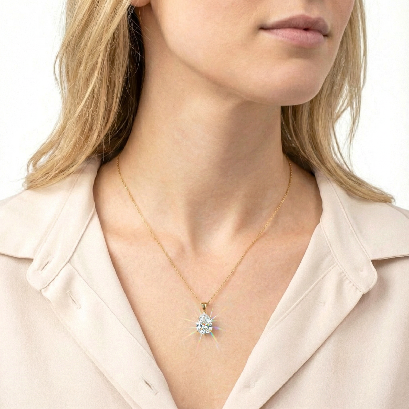 Model wearing the Luceria teardrop necklace with a pear-cut zirconia pendant in 18K gold vermeil.