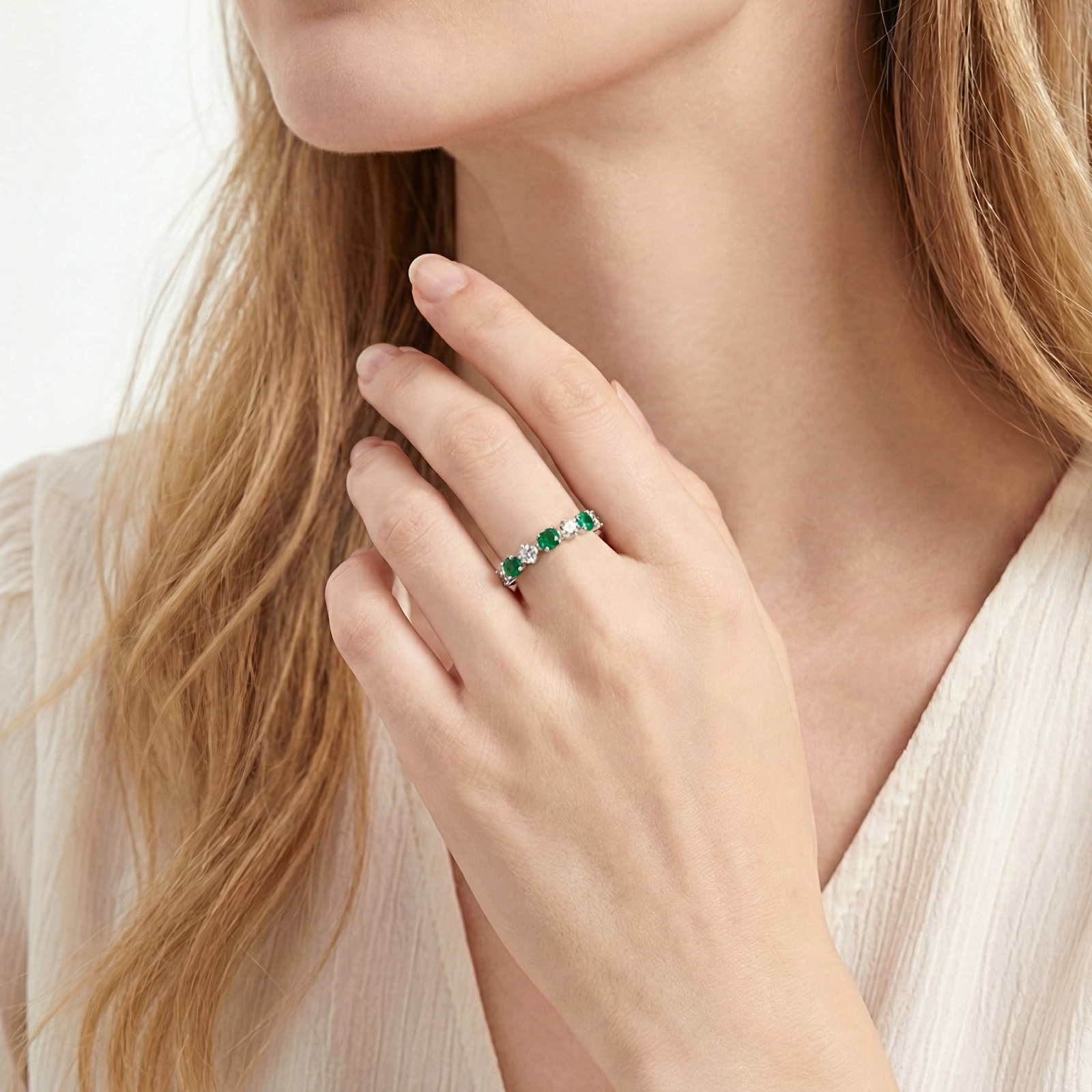 Model wearing the S925 silver Veridia eternity ring with green simulated emeralds and clear round-cut stones.