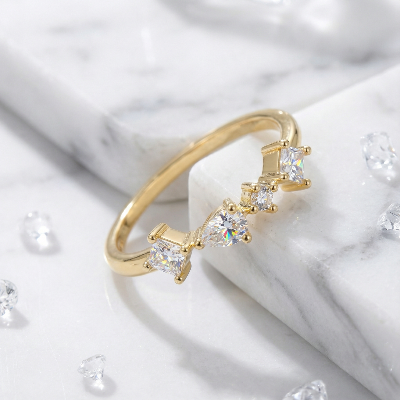 Close-up of the 18K gold vermeil Elysian Orbit ring showing the detail of the moissanite stones and low-profile setting.