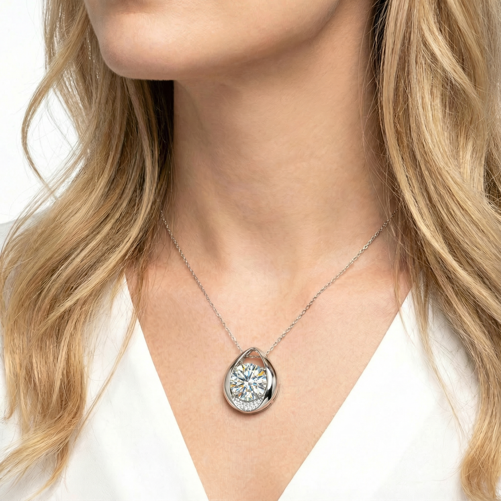 April birthstone teardrop necklace in sterling silver with a round cut zirconia worn by a model.