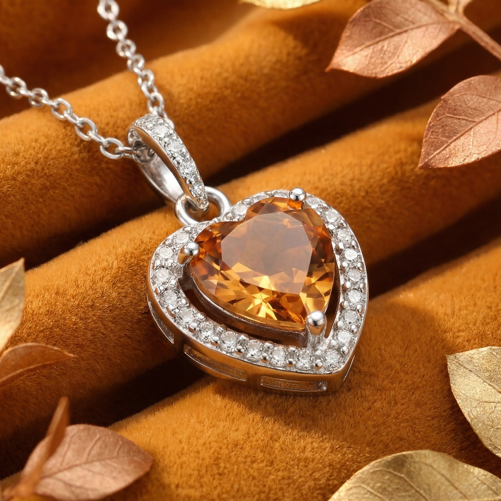 Heart-shaped simulated topaz necklace in S925 sterling silver halo setting on golden velvet fabric.