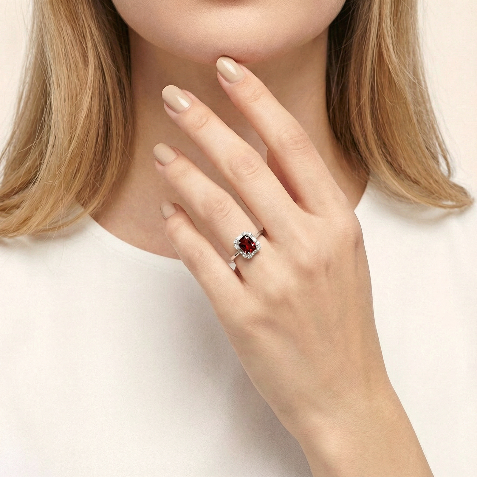Woman wearing the Marcella octagon cut red garnet silver ring on her finger.