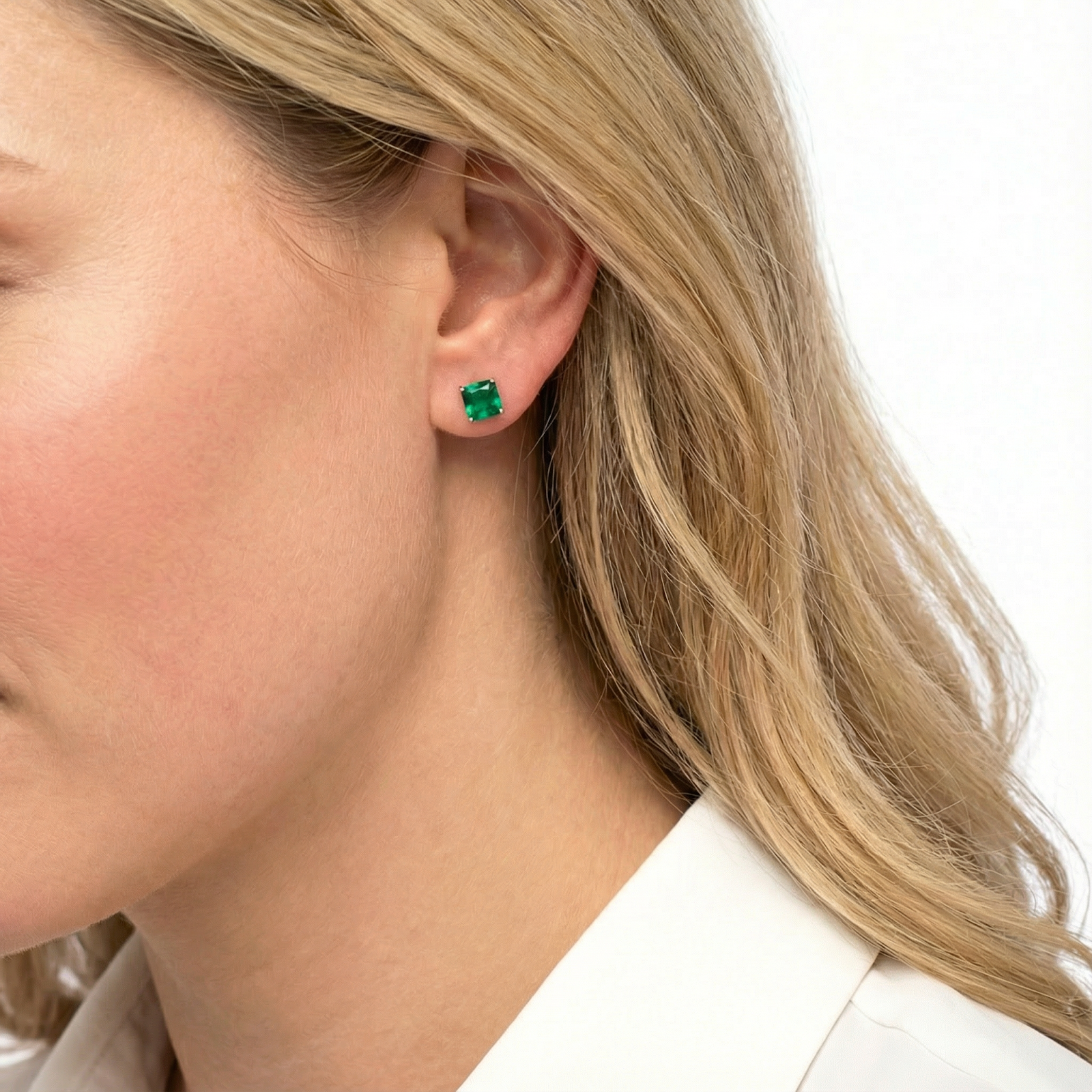 Profile view of a model wearing a square-cut simulated emerald earring in 18K rose gold vermeil.