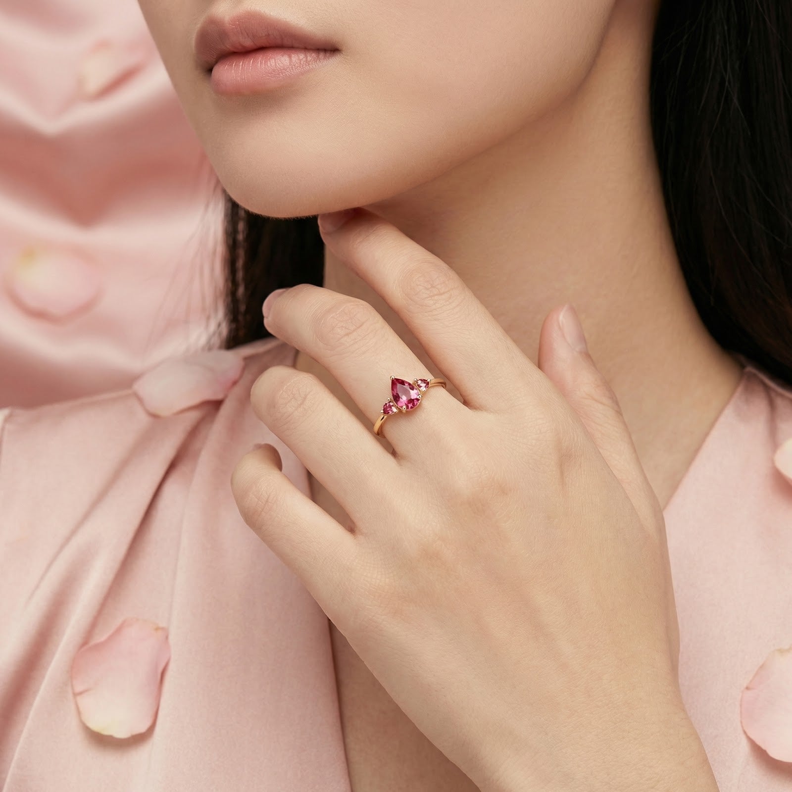 Woman wearing the 18K gold vermeil Roselind ring with pink tourmaline stones on her finger.