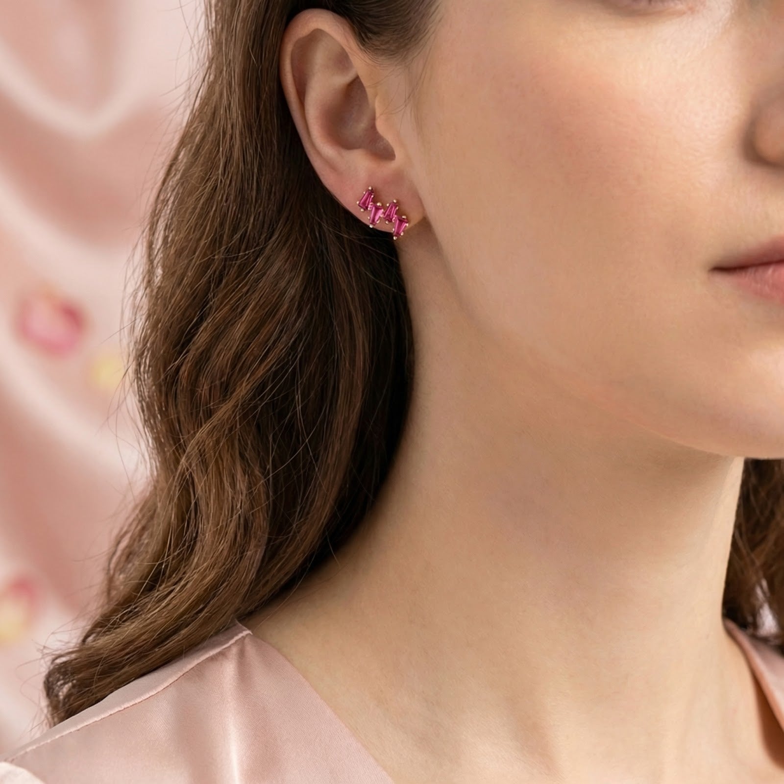Side profile of a model wearing the Thalissa Cascade gold vermeil earrings with pink tourmaline stones.