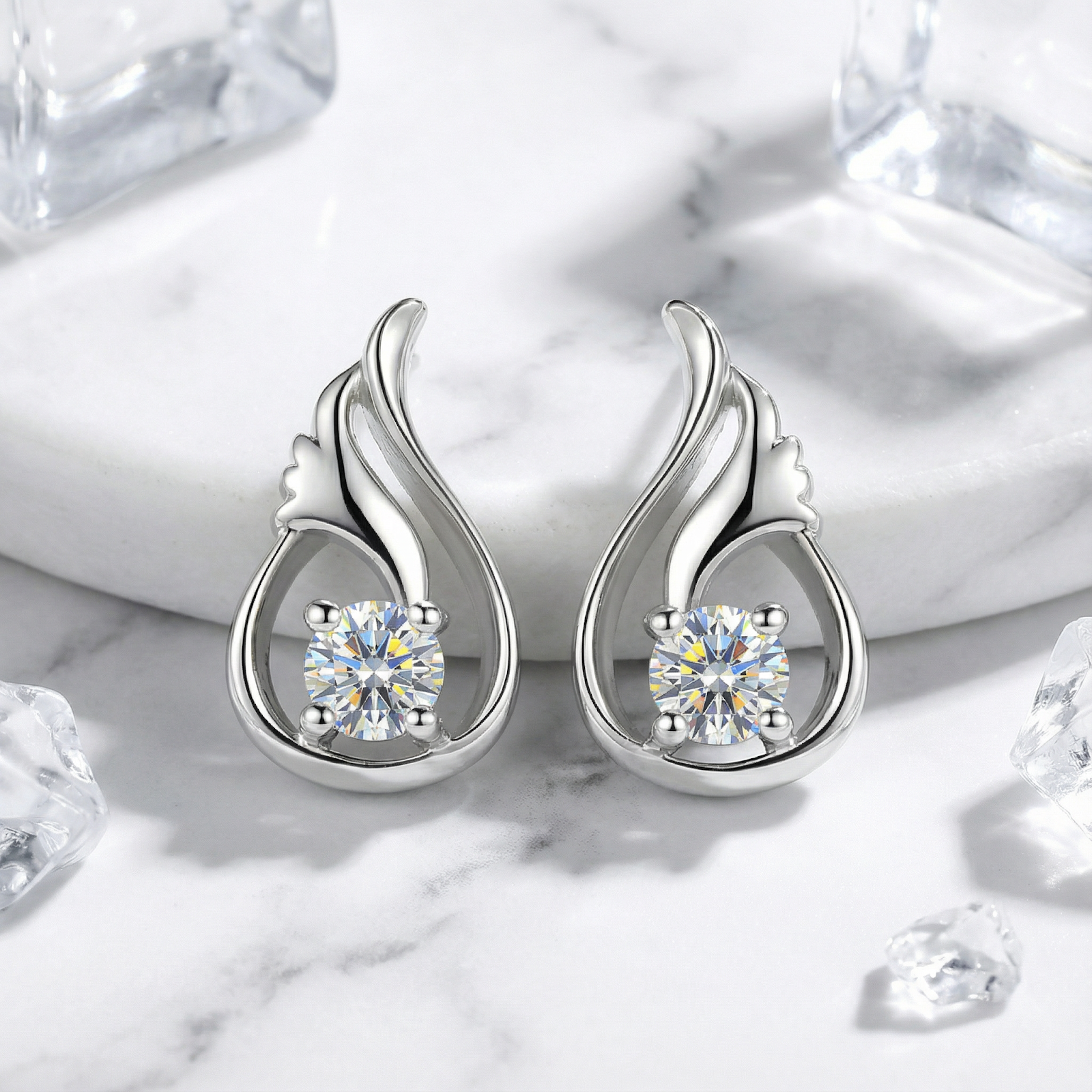 Sterling silver tulip bud earrings with round cut zirconia stones on a marble surface with ice accents.