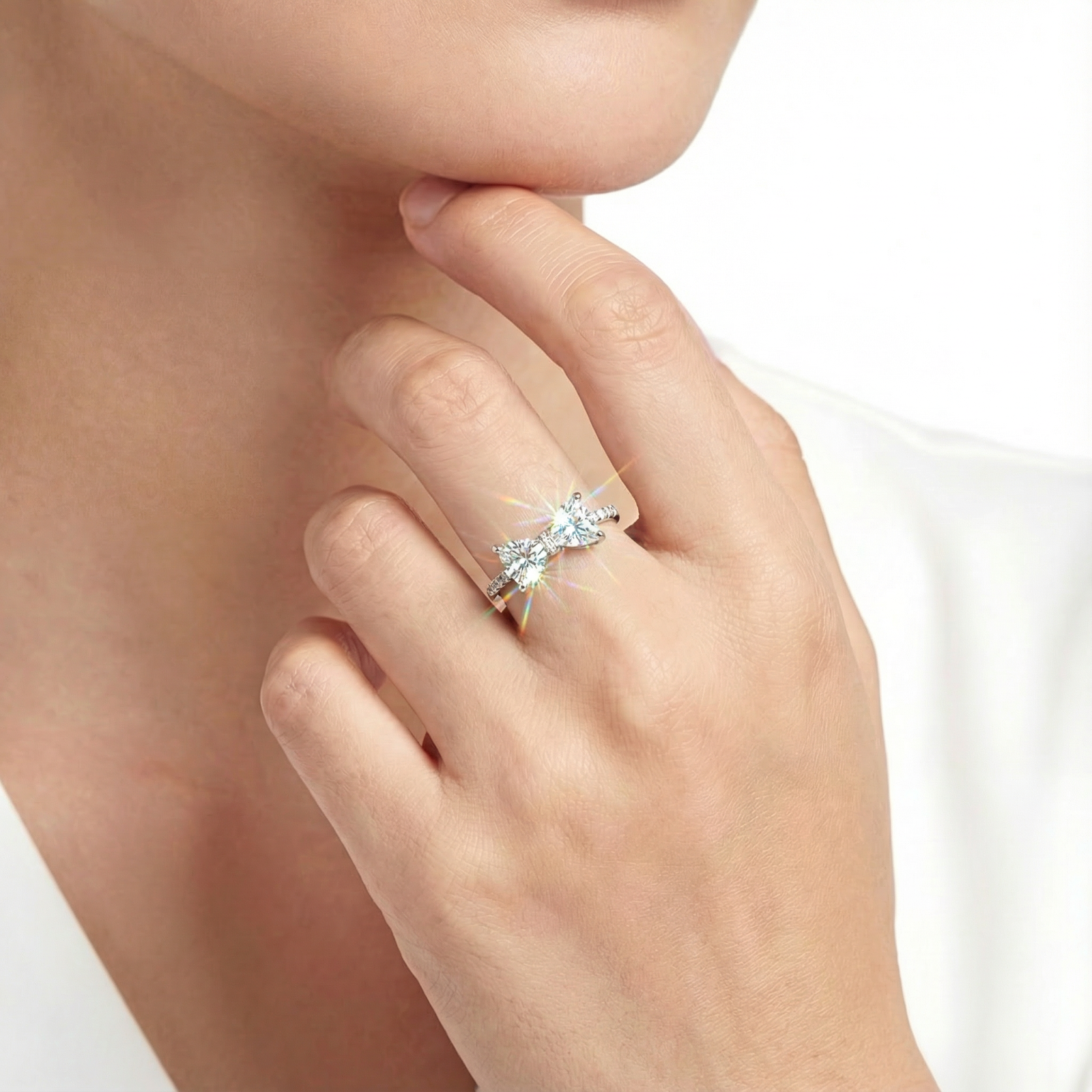 Model wearing the Lysandra bow ring in sterling silver with sparkling trillion-cut simulated diamonds.