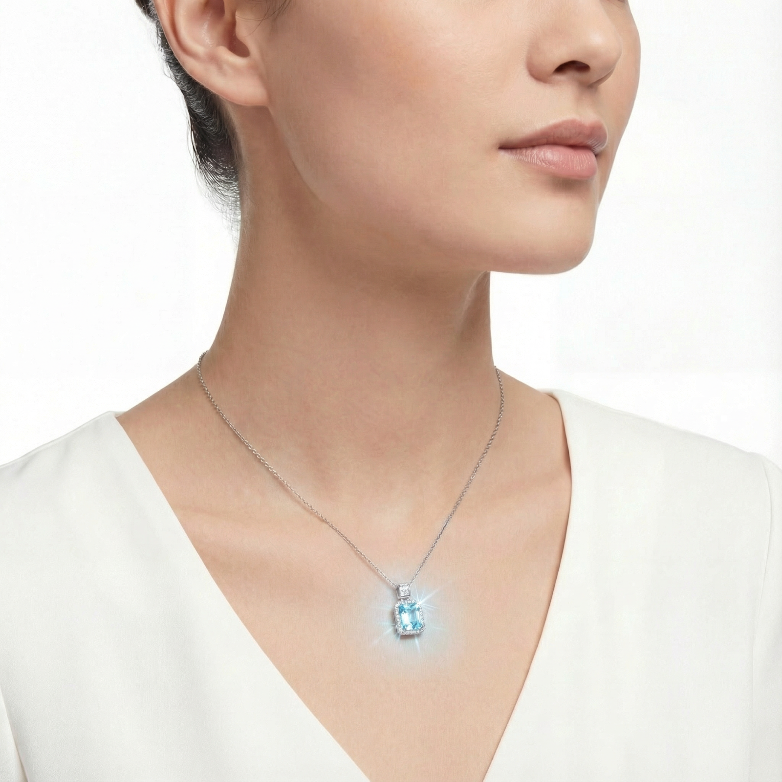 Model wearing the Caelum emerald-cut simulated aquamarine pendant in sterling silver.