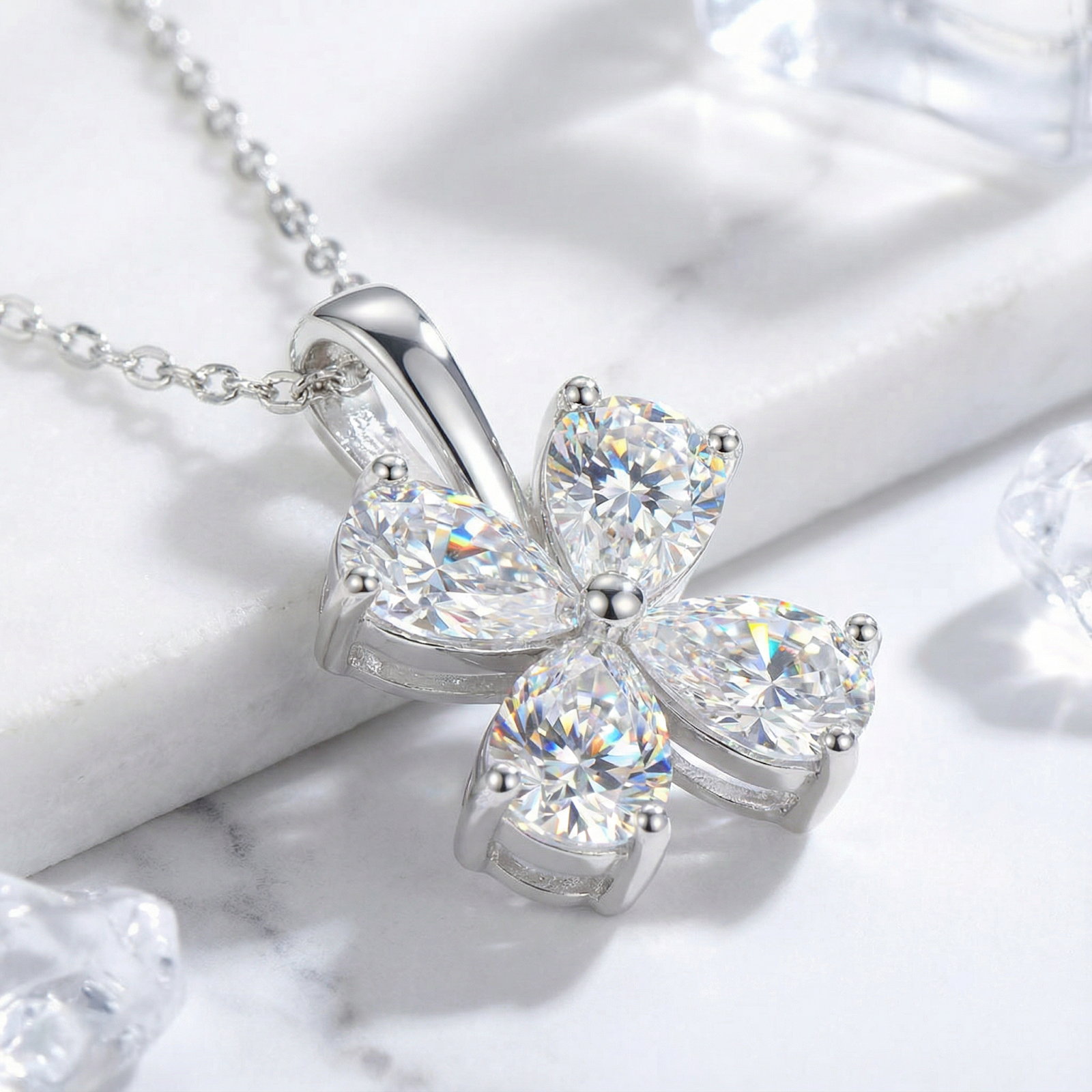 Close-up of a sterling silver clover pendant featuring four pear-cut 5A zirconia stones in a prong setting.