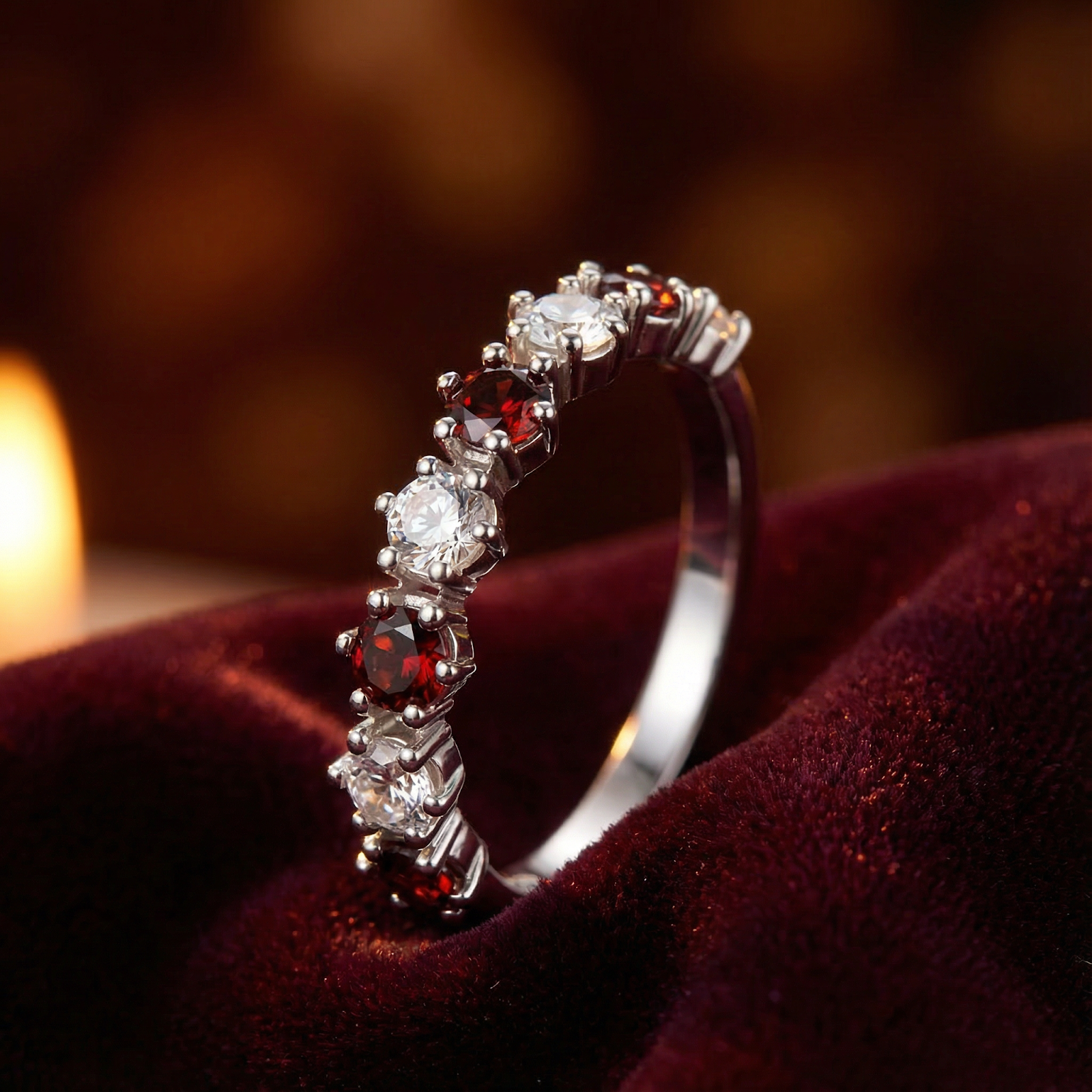 Side profile of the Aeliana eternity ring showing round cut simulated garnets and clear stones in a silver setting.